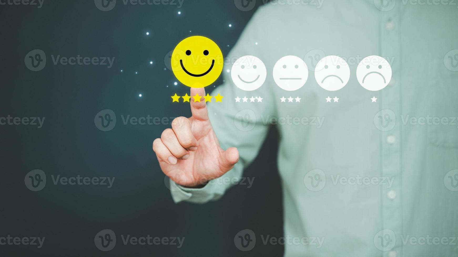 Man touching the virtual screen on the happy smiley face icon to give satisfaction in service. Rating very impressed. Customer service, testimonial and satisfaction concept. photo