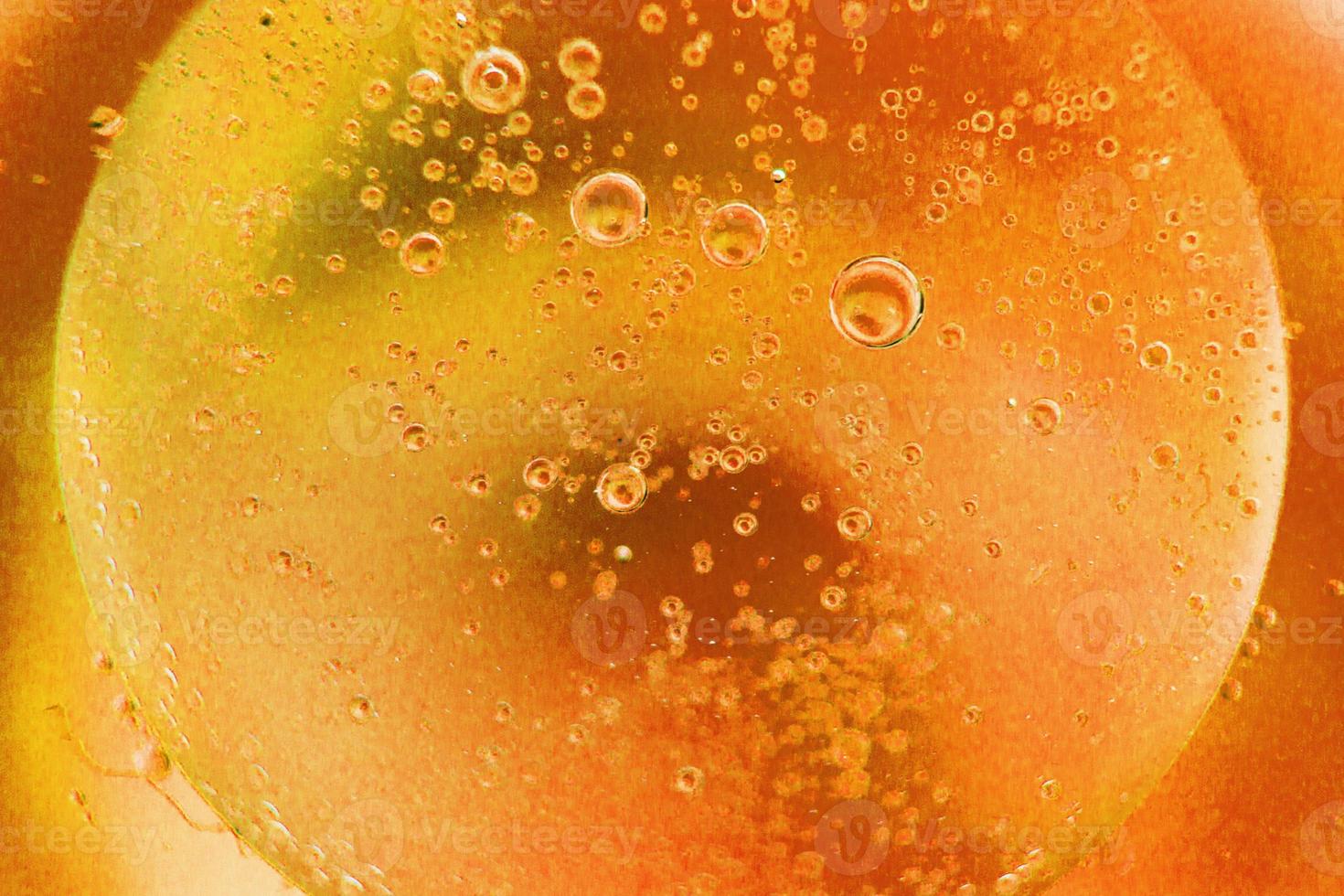 abstract light orange background with oil circles . oil bubbles of water close up. fiery circle bubbles background photo