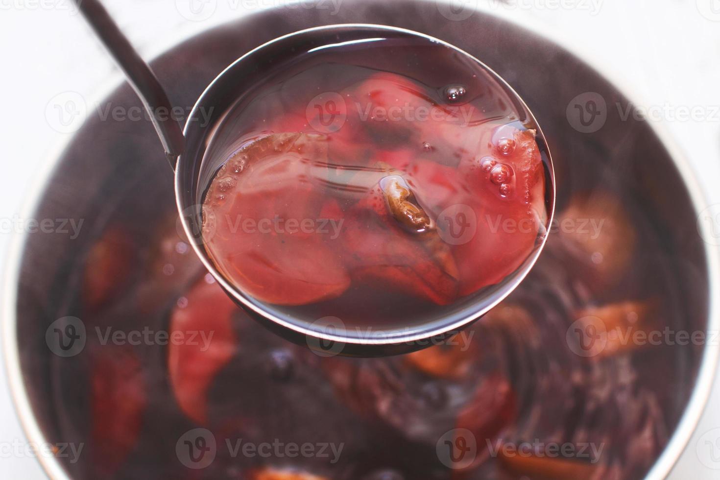 ladle with compote over a pan photo