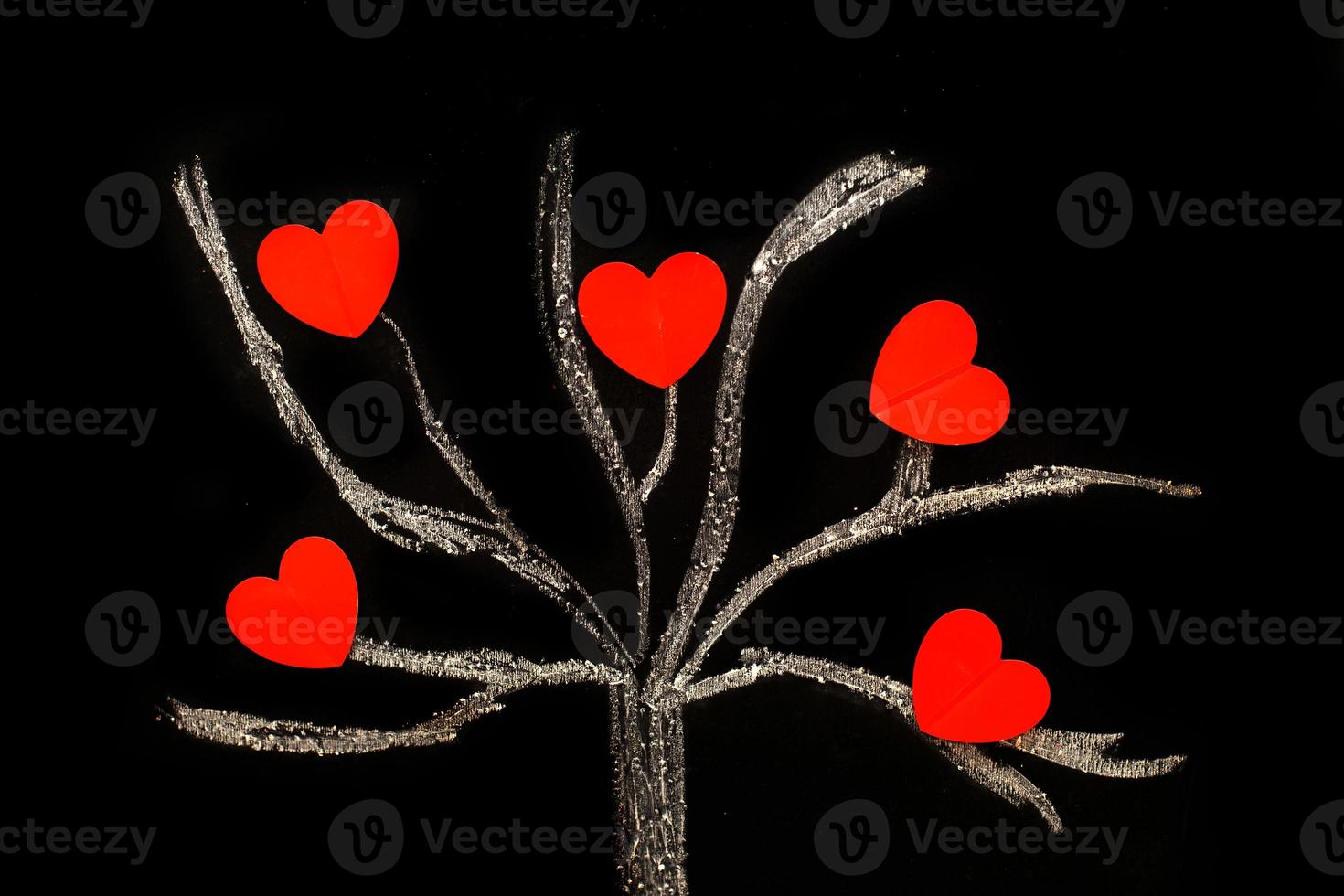 chalk drawing tree on a black chalkboard with red hearts on a tree photo