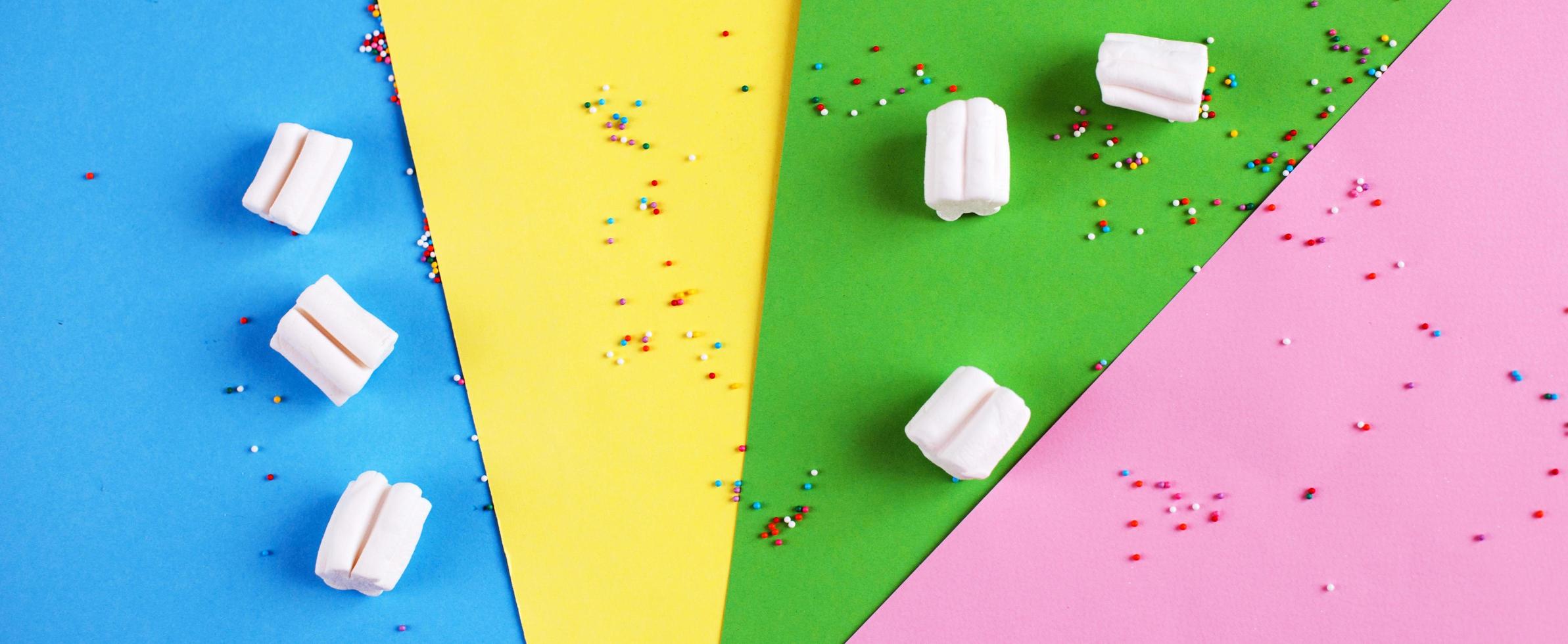 Colored marshmallow composition on on colorful background. Flat lay, holiday concept. banner photo