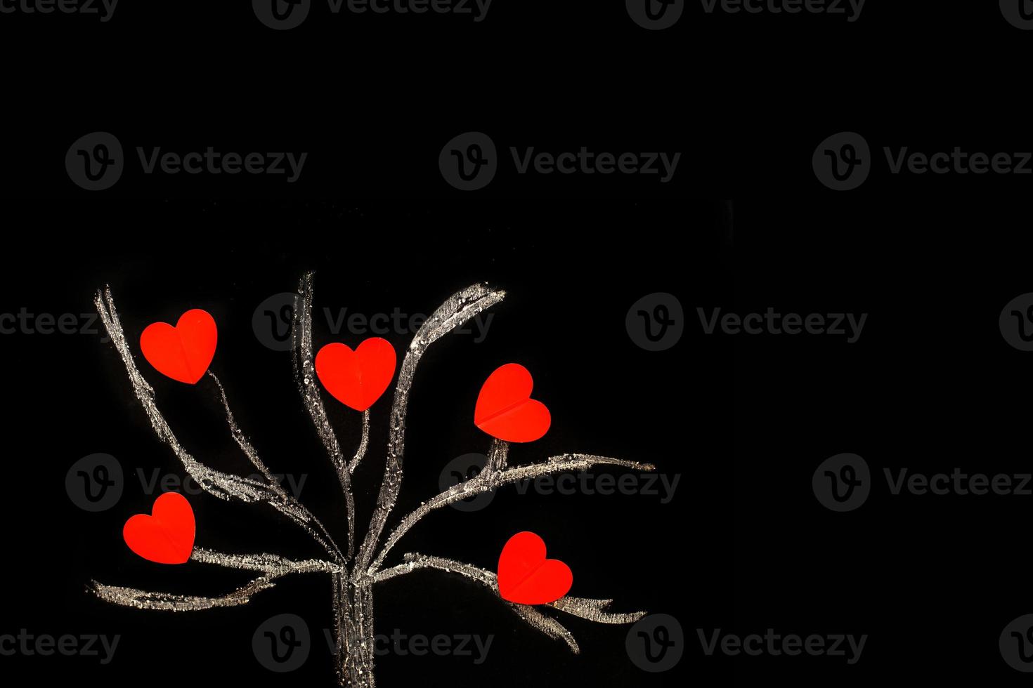 chalk drawing tree on a black chalkboard with red hearts on a tree photo