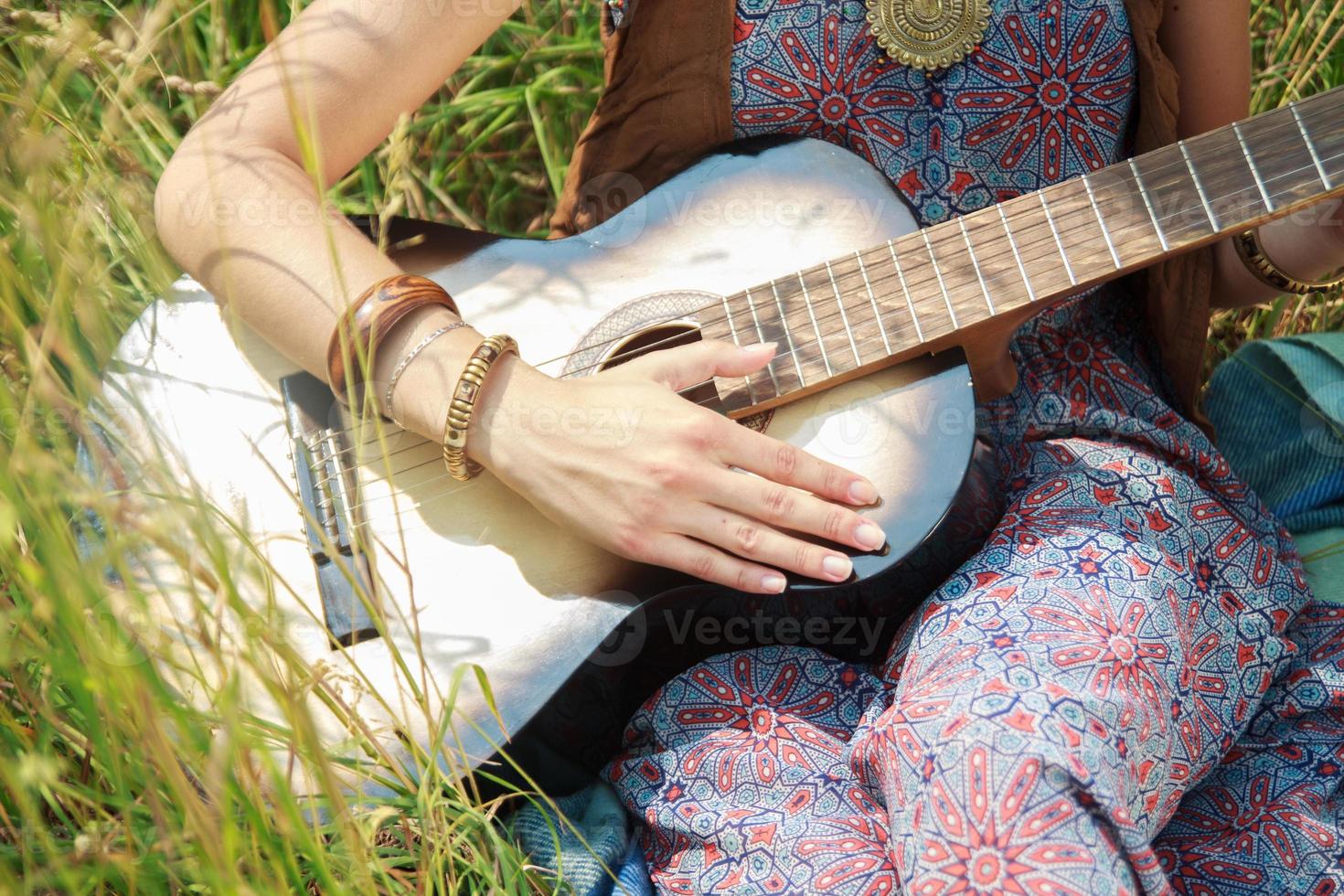 girl playing on the guitar photo