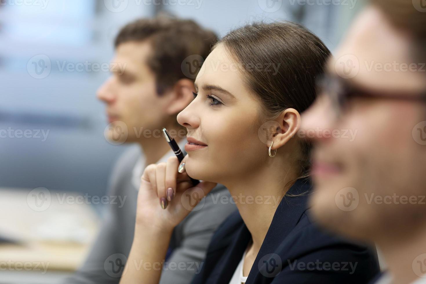 Group of business people attending a conference photo