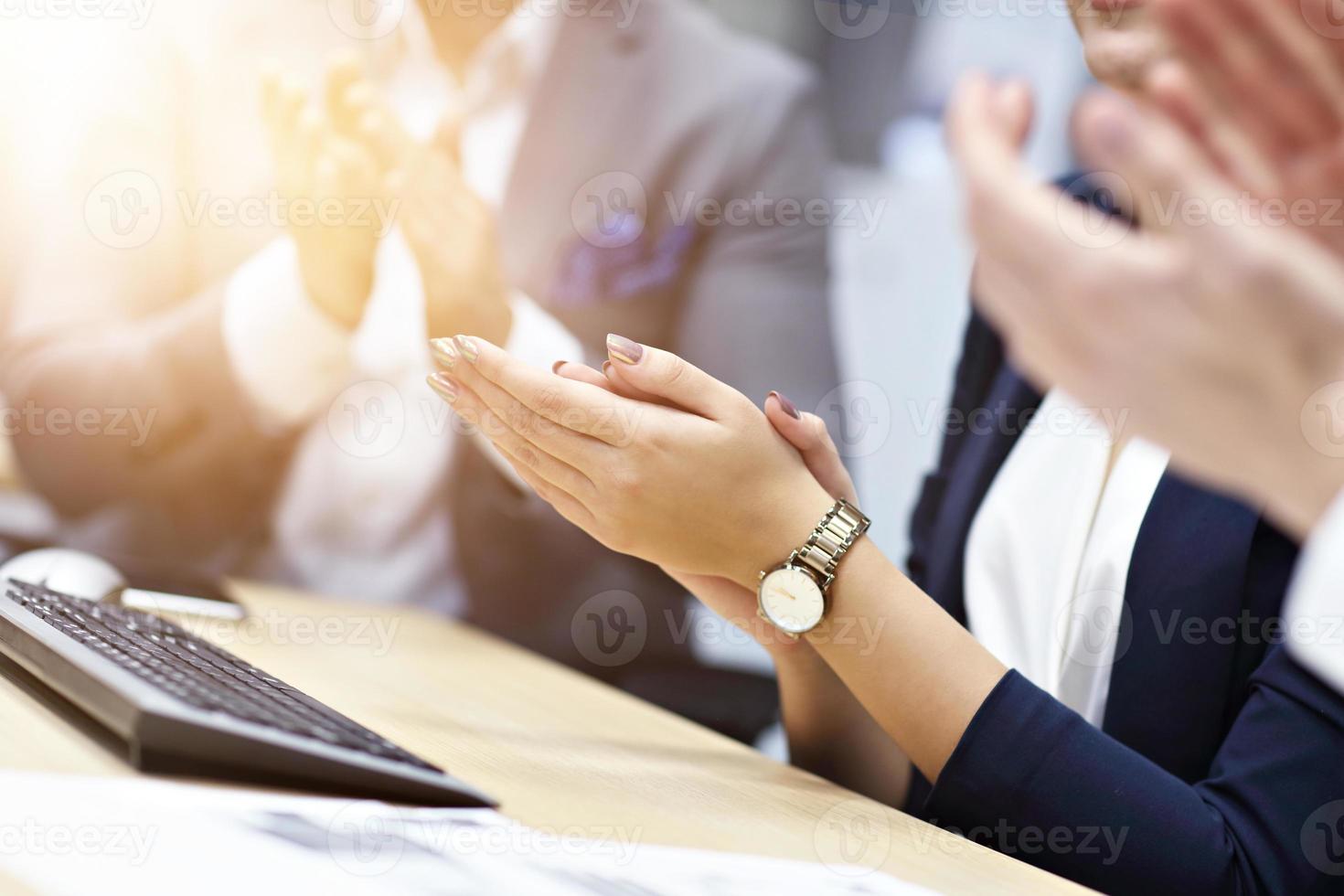 Midsection of businesspeople clapping hands at conference photo