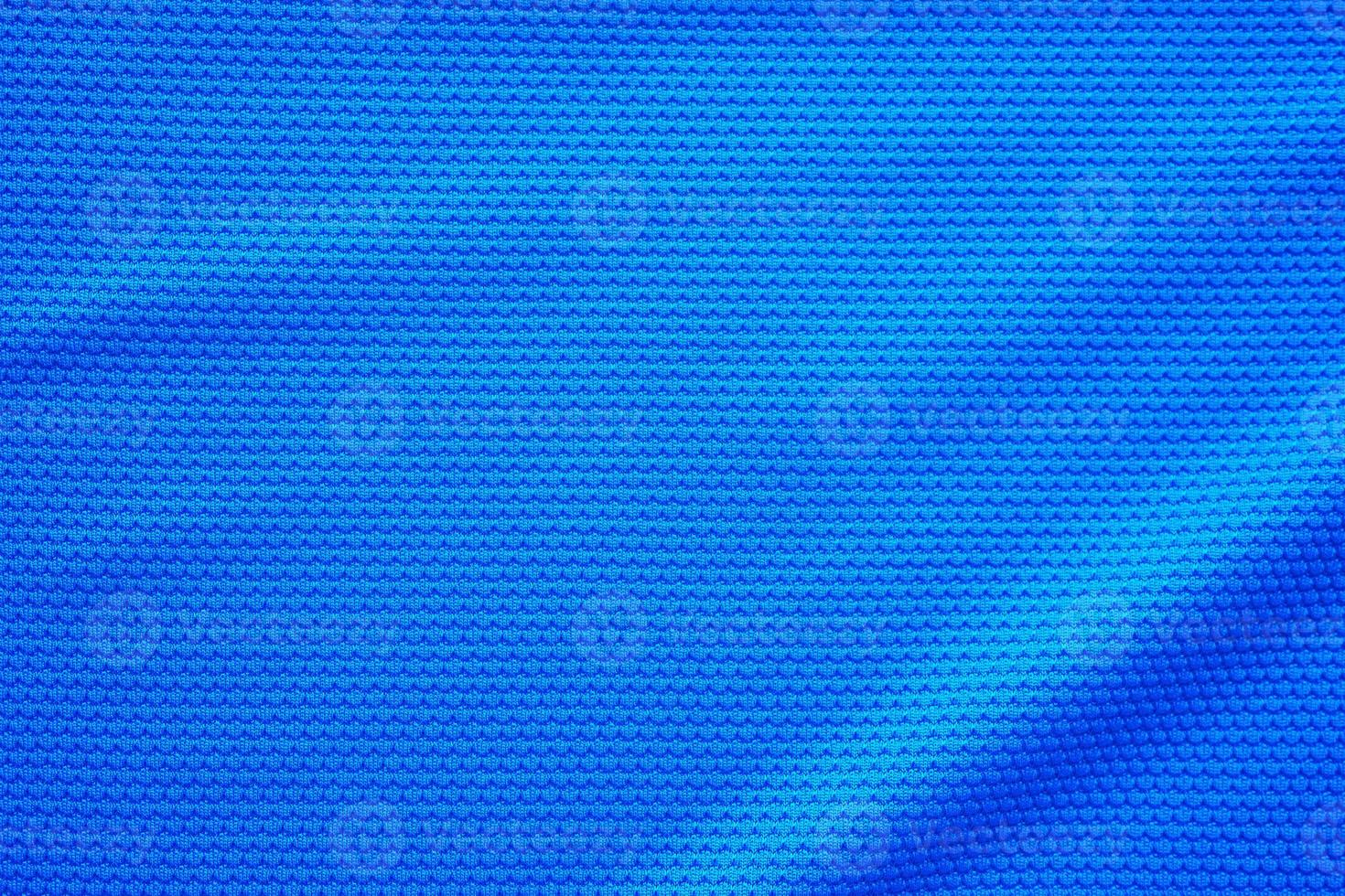 Blue football jersey clothing fabric texture sports wear background, close up top view photo