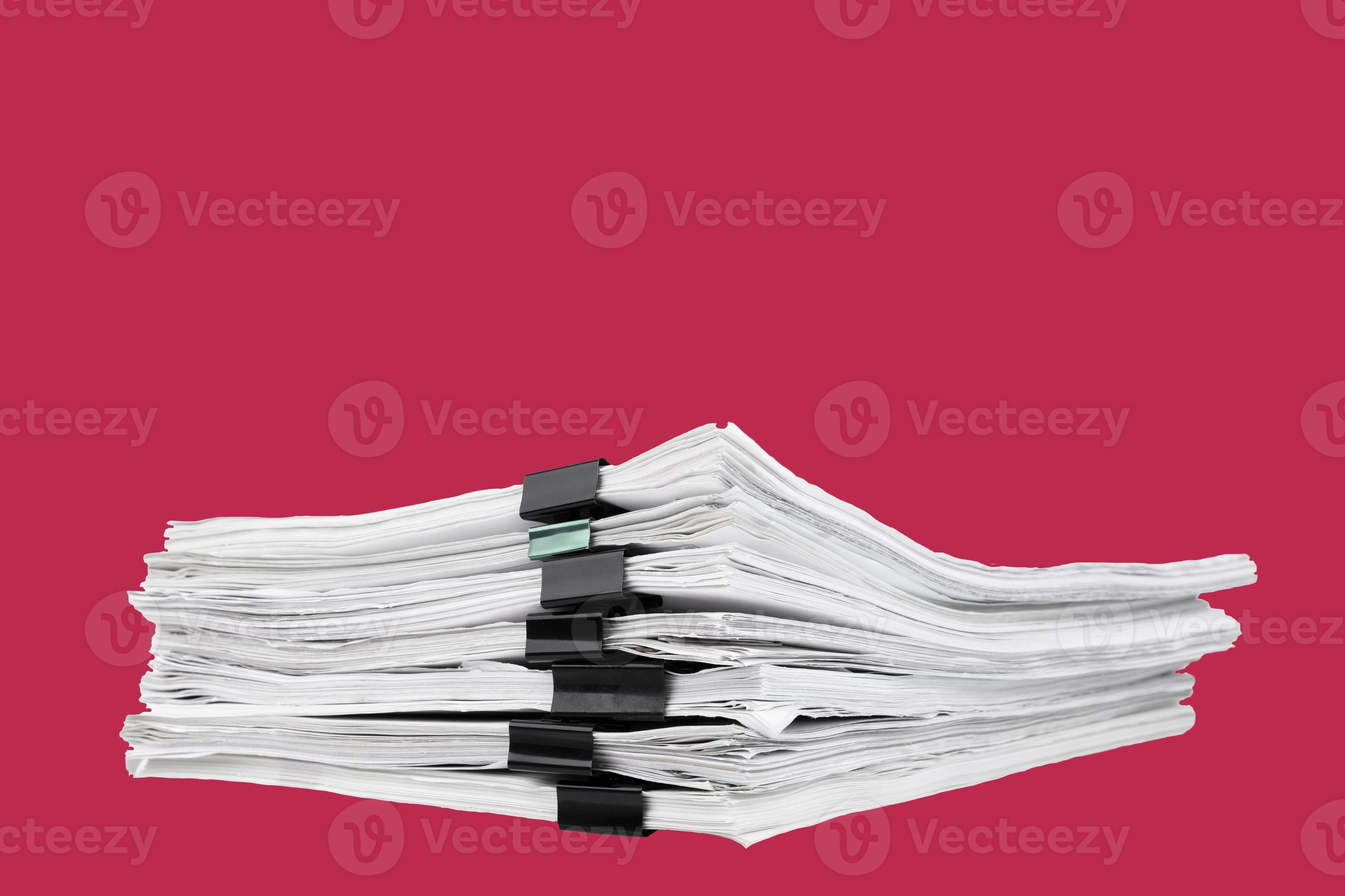 A stack of papers with paper clips, office folders on a carmine red