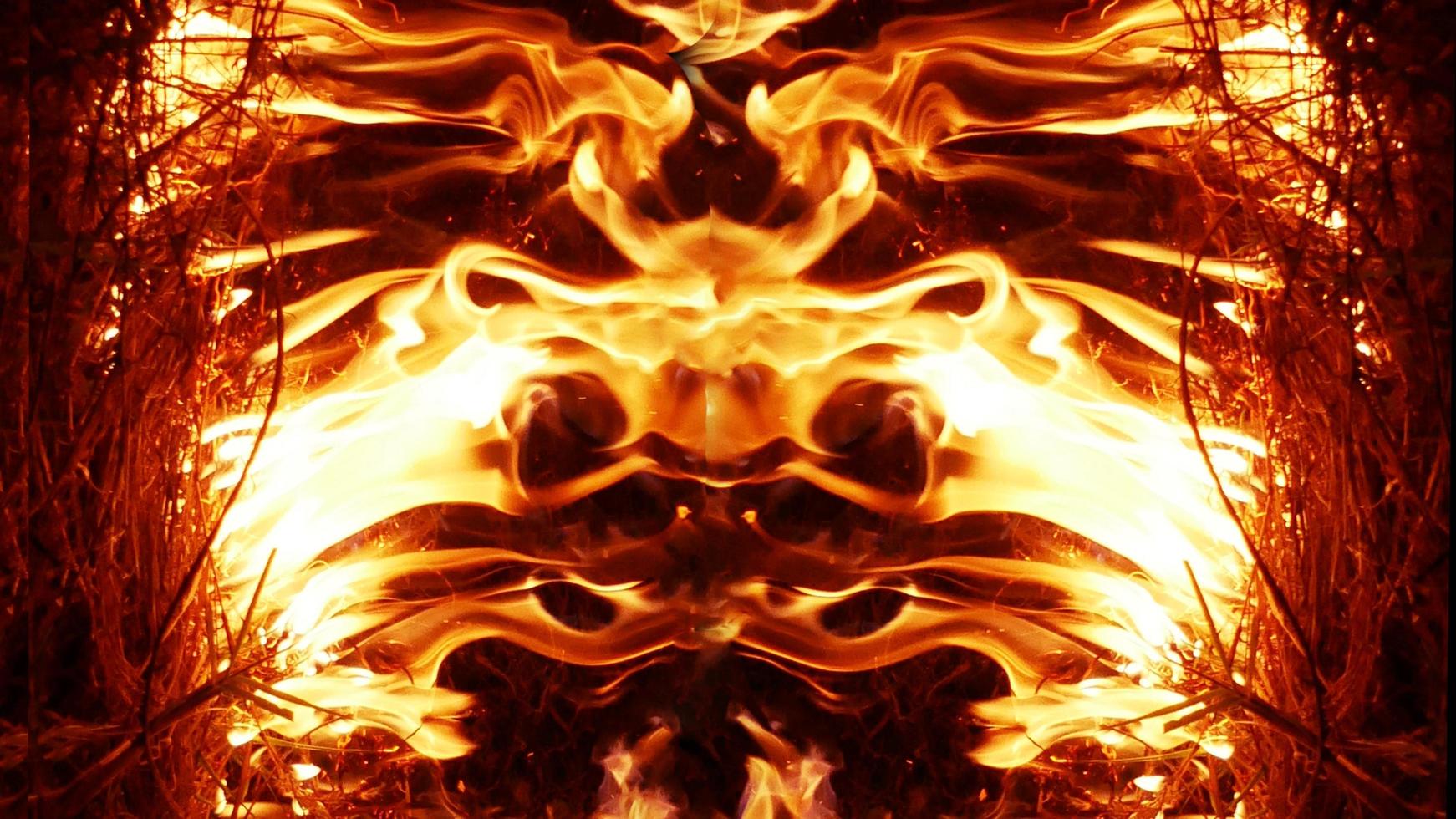 A beautiful flame shaped as imagined. like from hell, showing a dangerous and fiery fervor, black background. photo