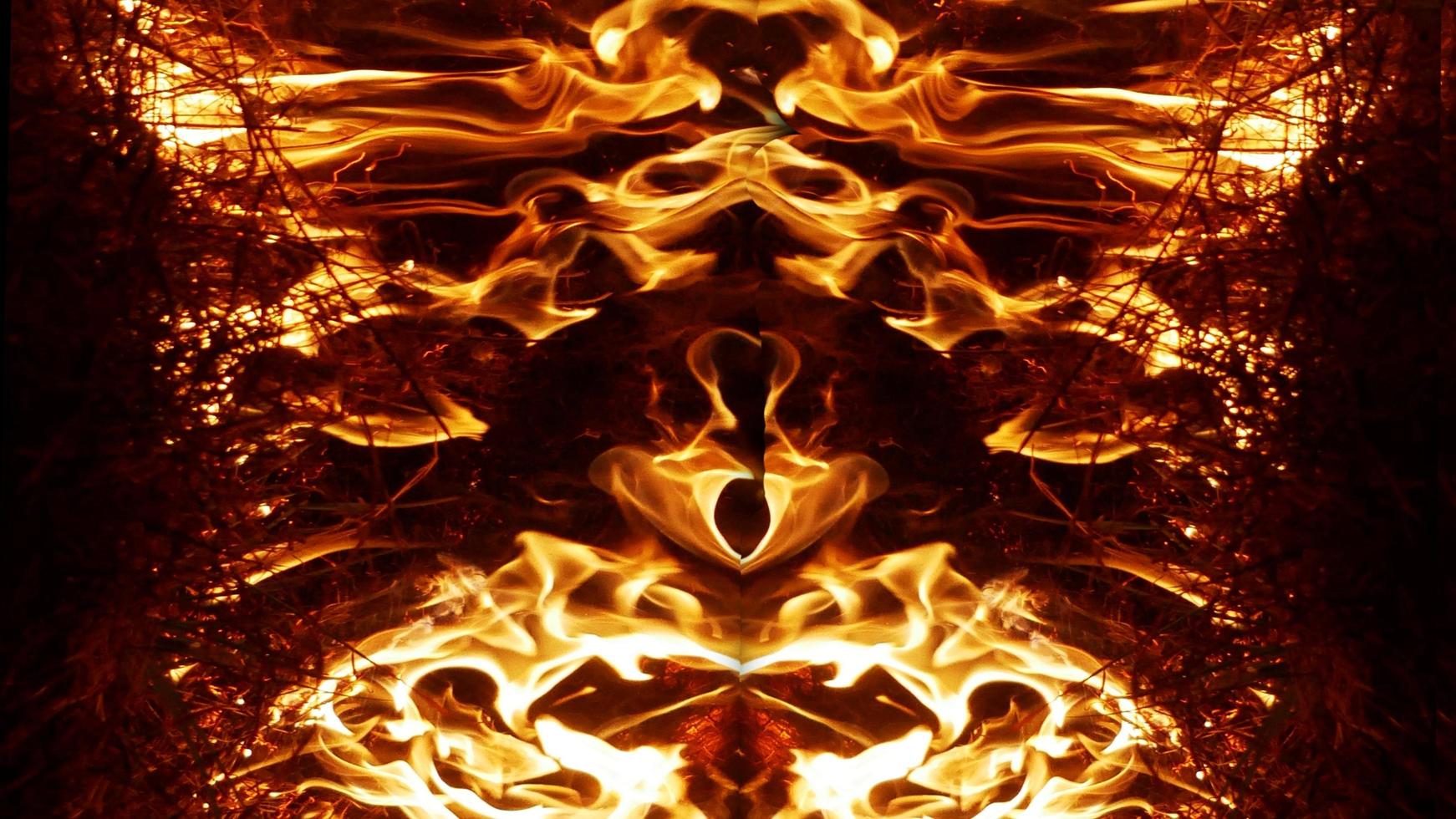 A beautiful flame shaped as imagined. like from hell, showing a dangerous and fiery fervor, black background. photo