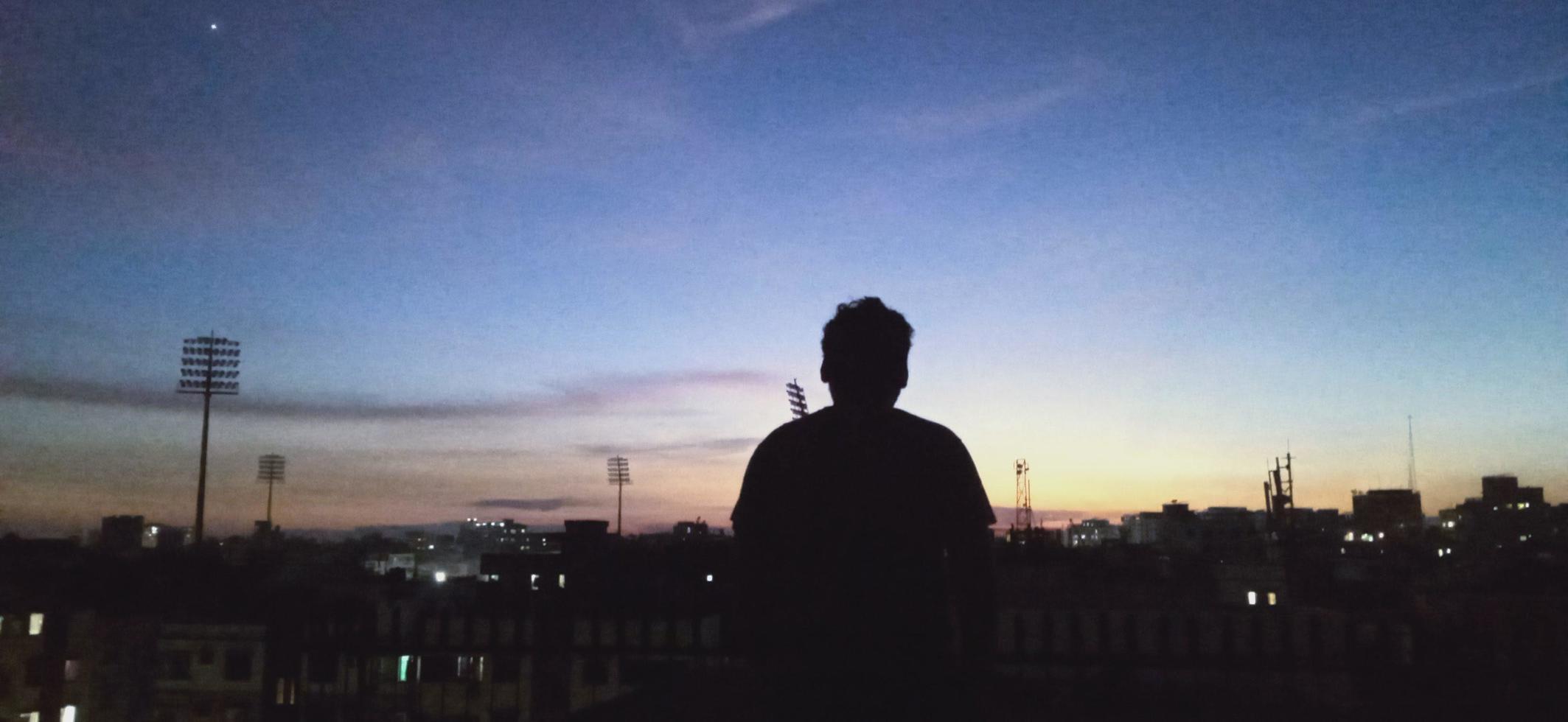 man standing in front of mirpur stadium bangladesh dhaka area sunset photo