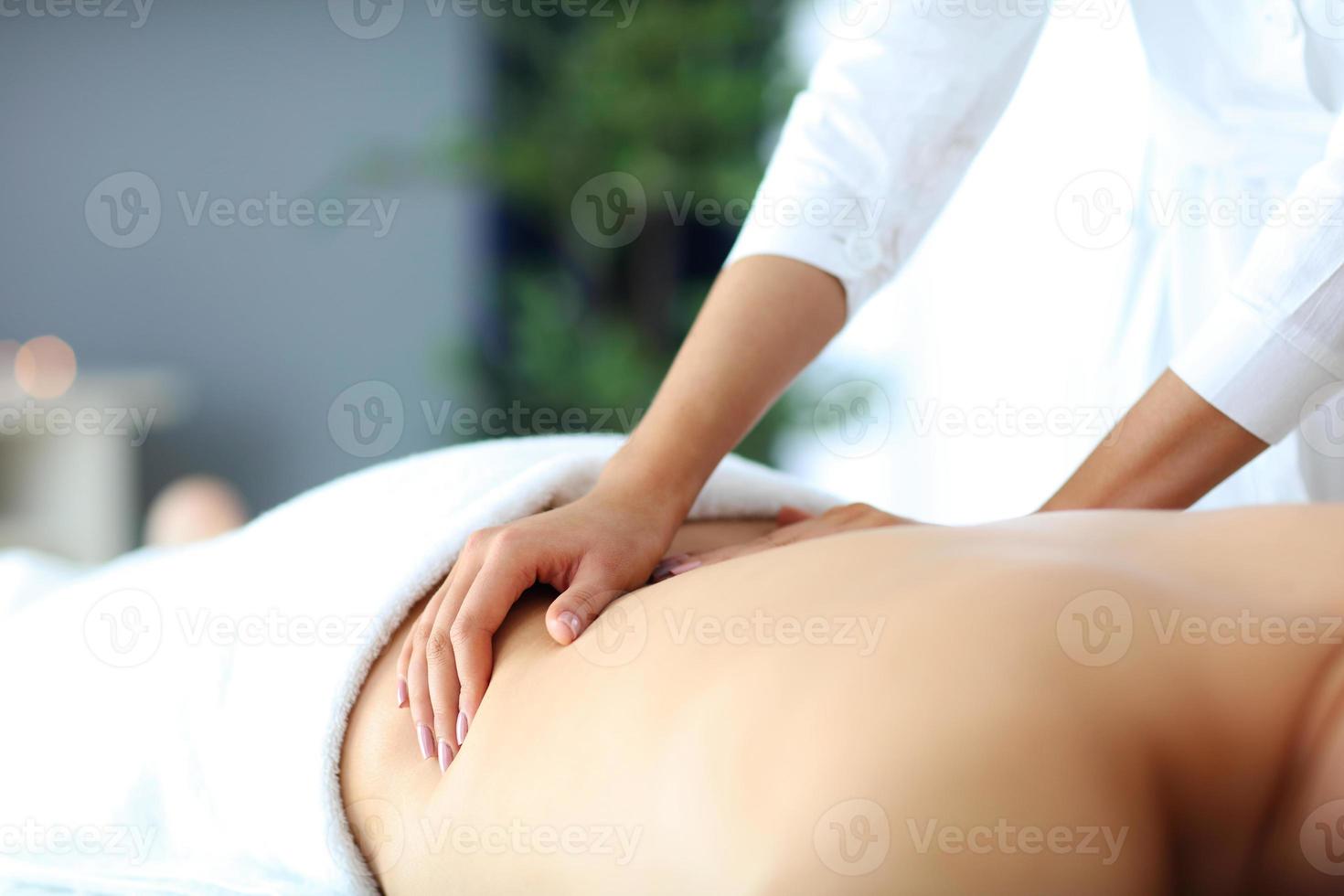 Handsome man having massage in spa salon photo