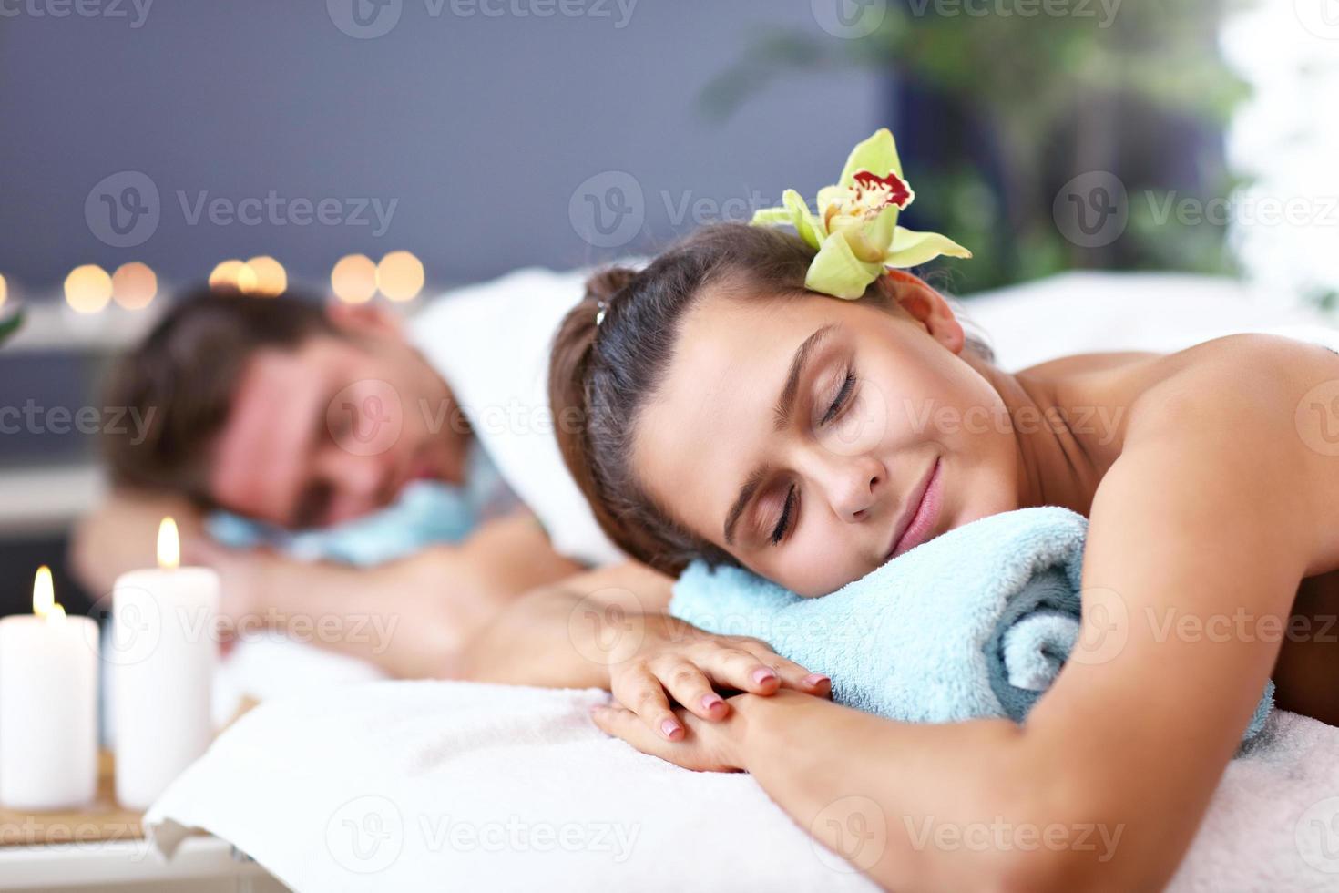 Adult happy couple relaxing in spa salon photo