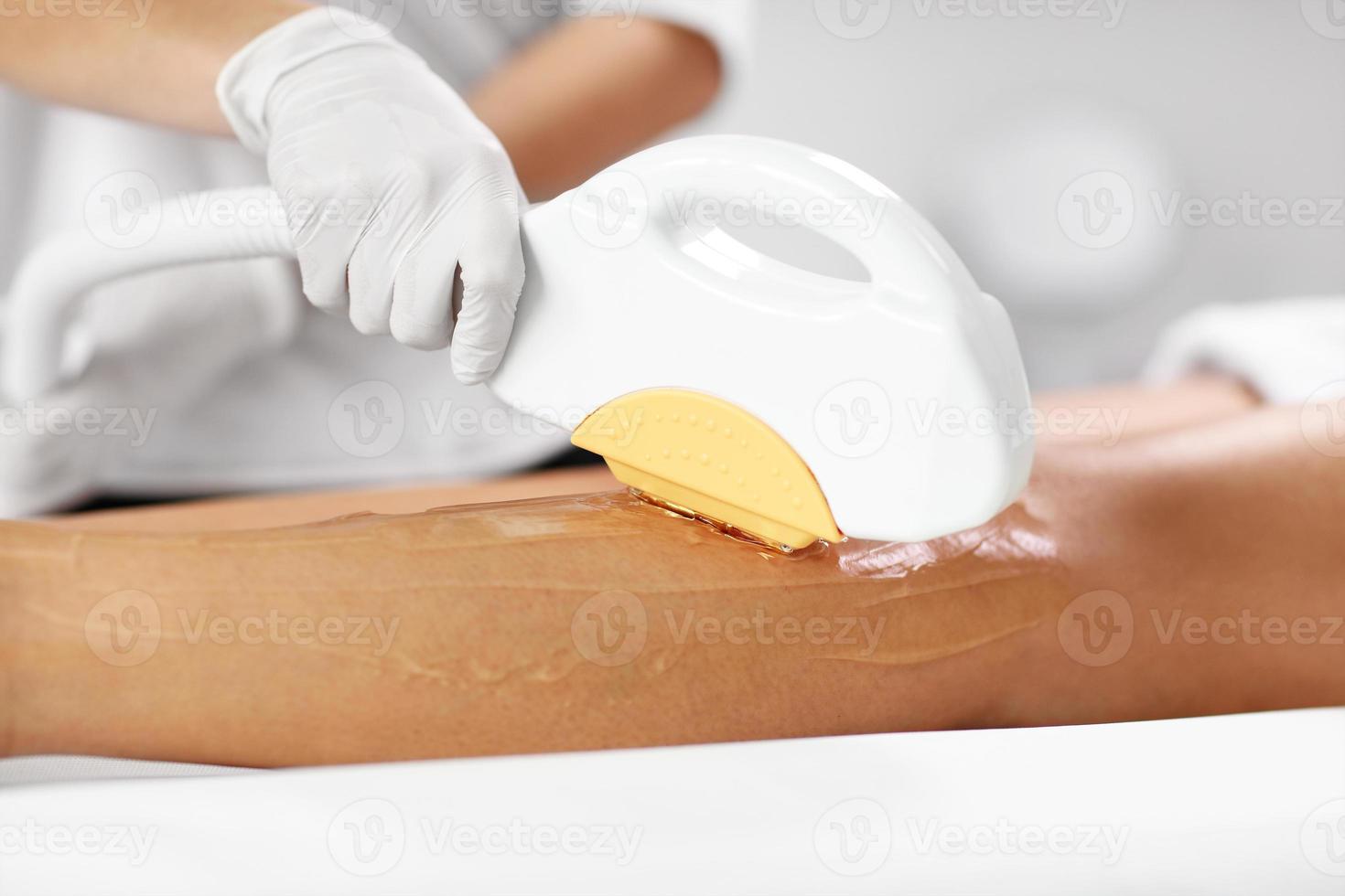 Beautician Giving Depilation Laser Treatment To Woman On Legs photo