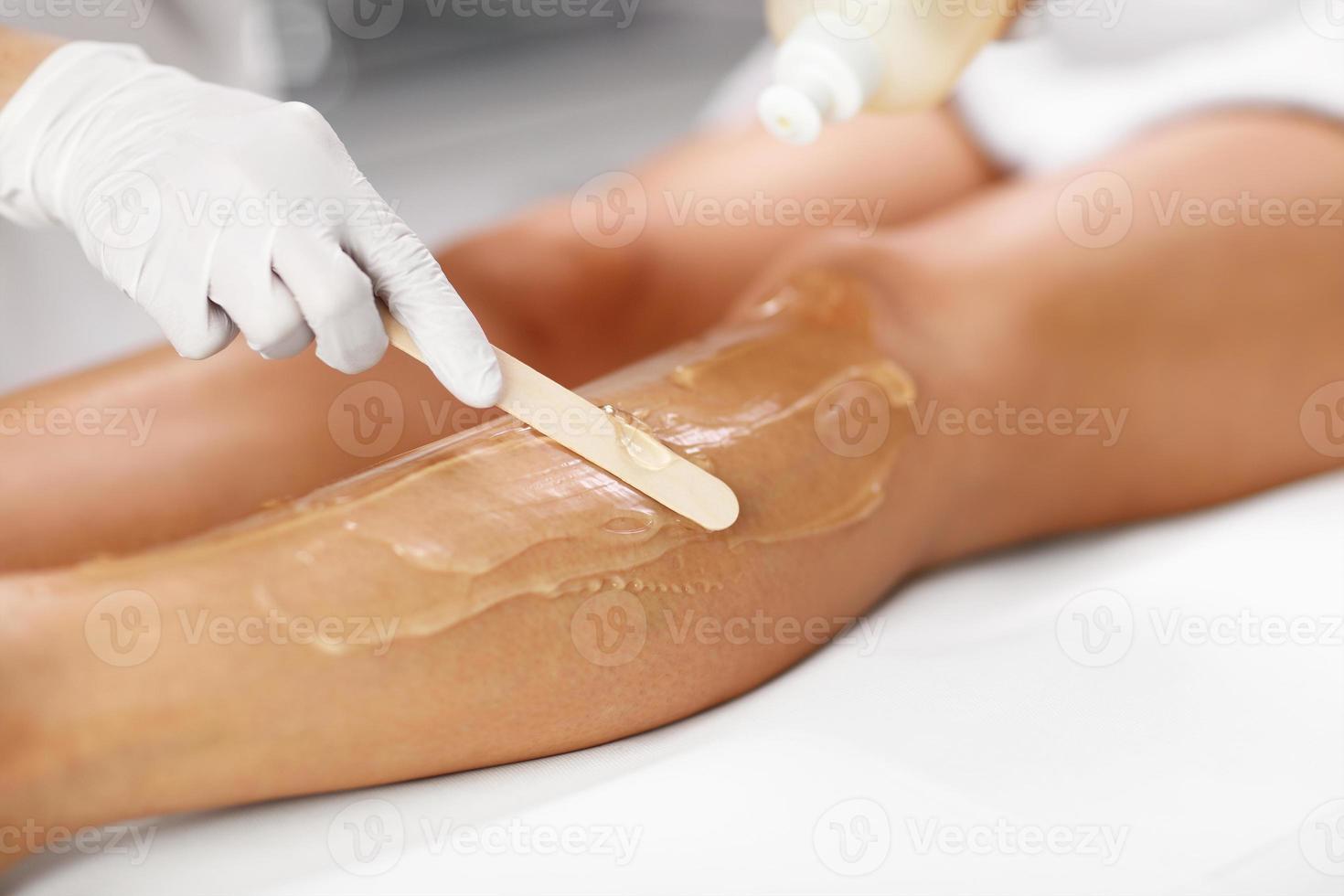 Beautician Giving Depilation Laser Treatment To Woman On Legs photo