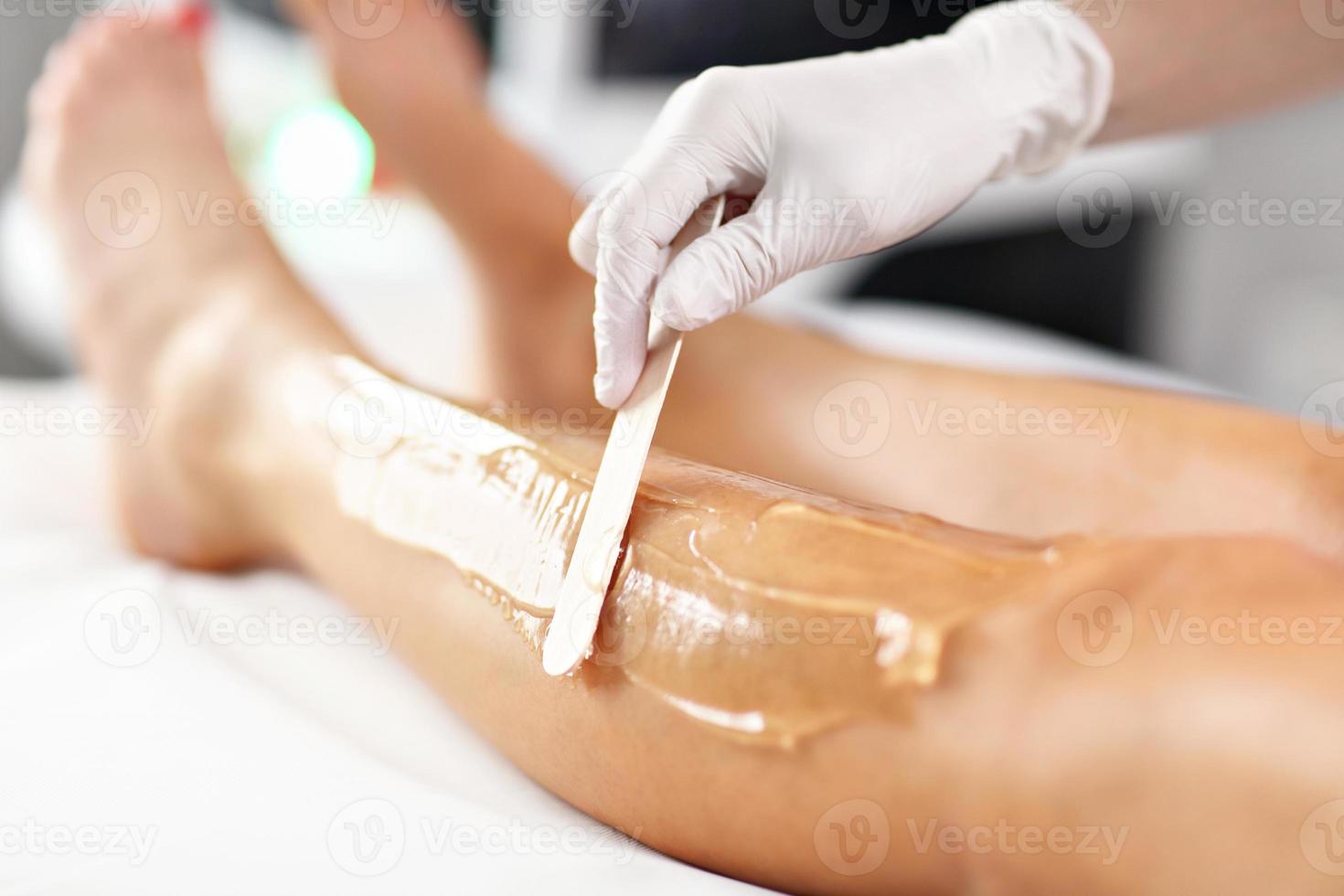 Beautician Giving Depilation Laser Treatment To Woman On Legs photo