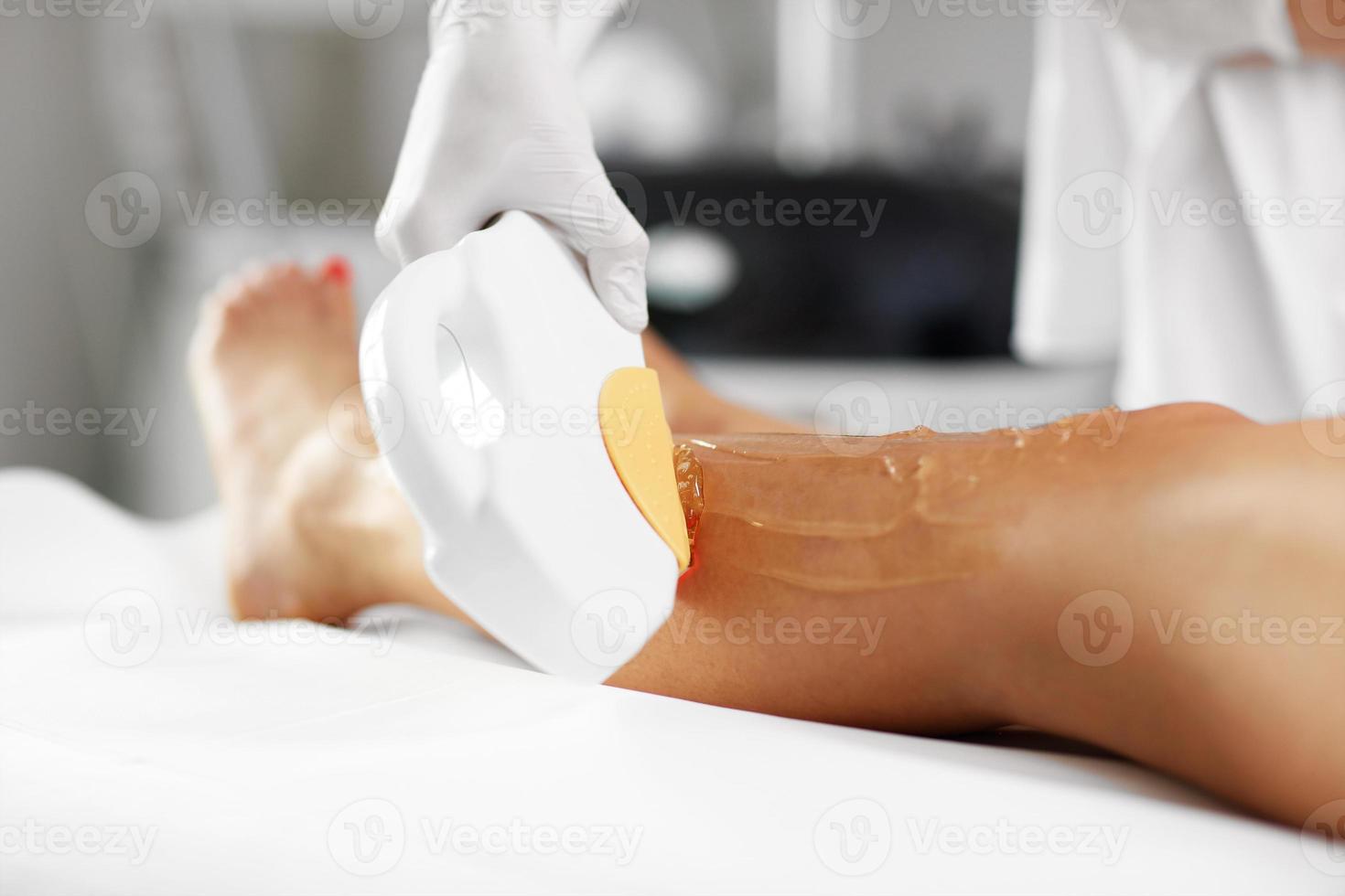 Beautician Giving Depilation Laser Treatment To Woman On Legs photo