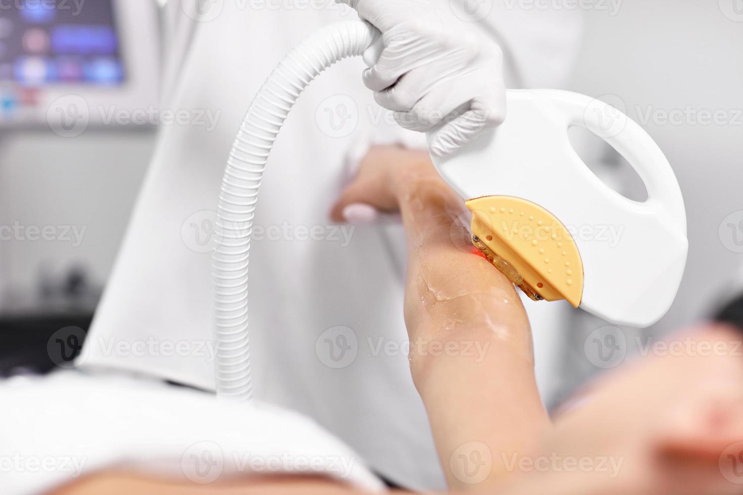 Beautician Giving Depilation Laser Treatment To Woman On Arms photo