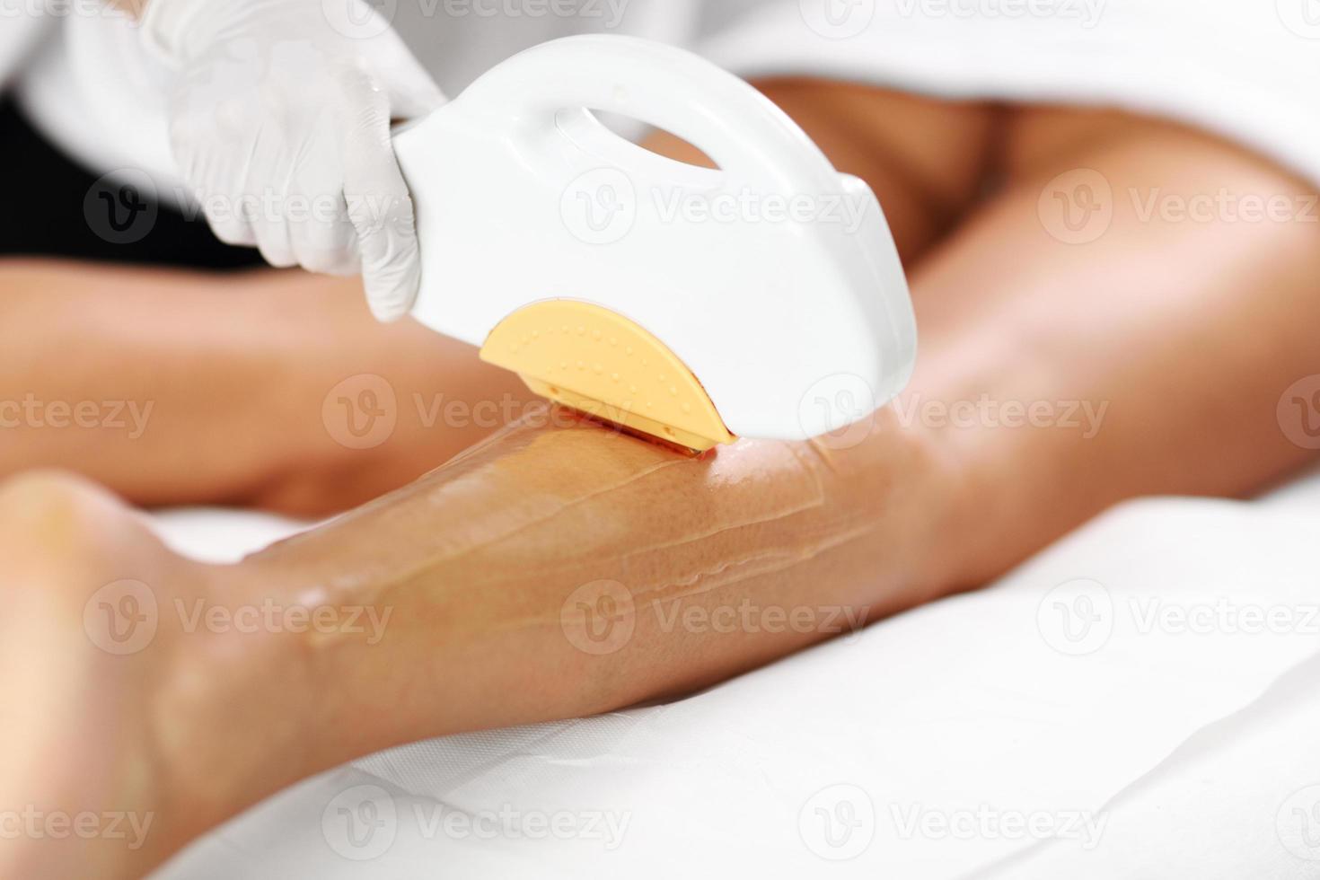 Beautician Giving Depilation Laser Treatment To Woman On Legs photo