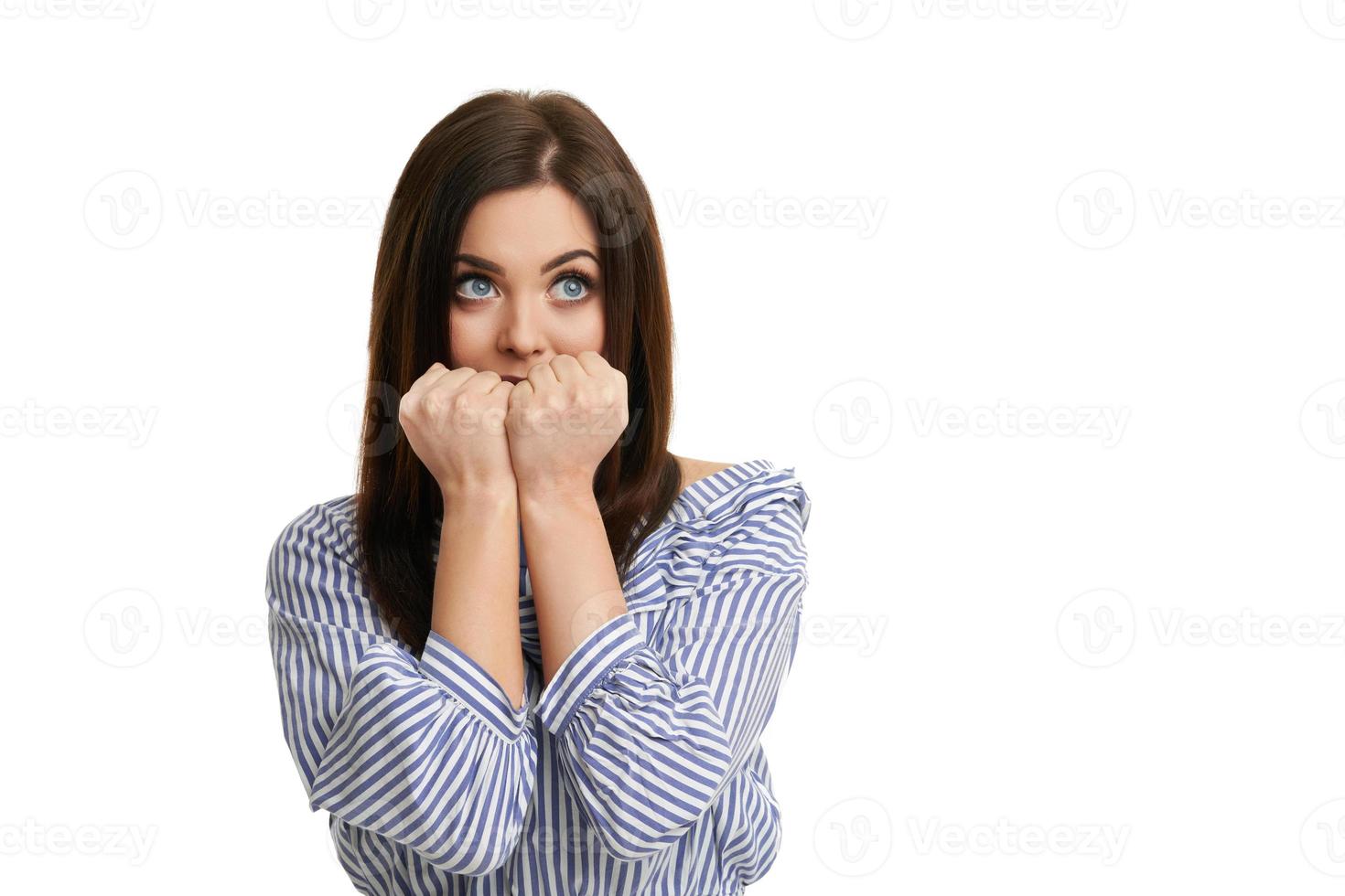 Shocked girl covers her face with hands isolated on white photo