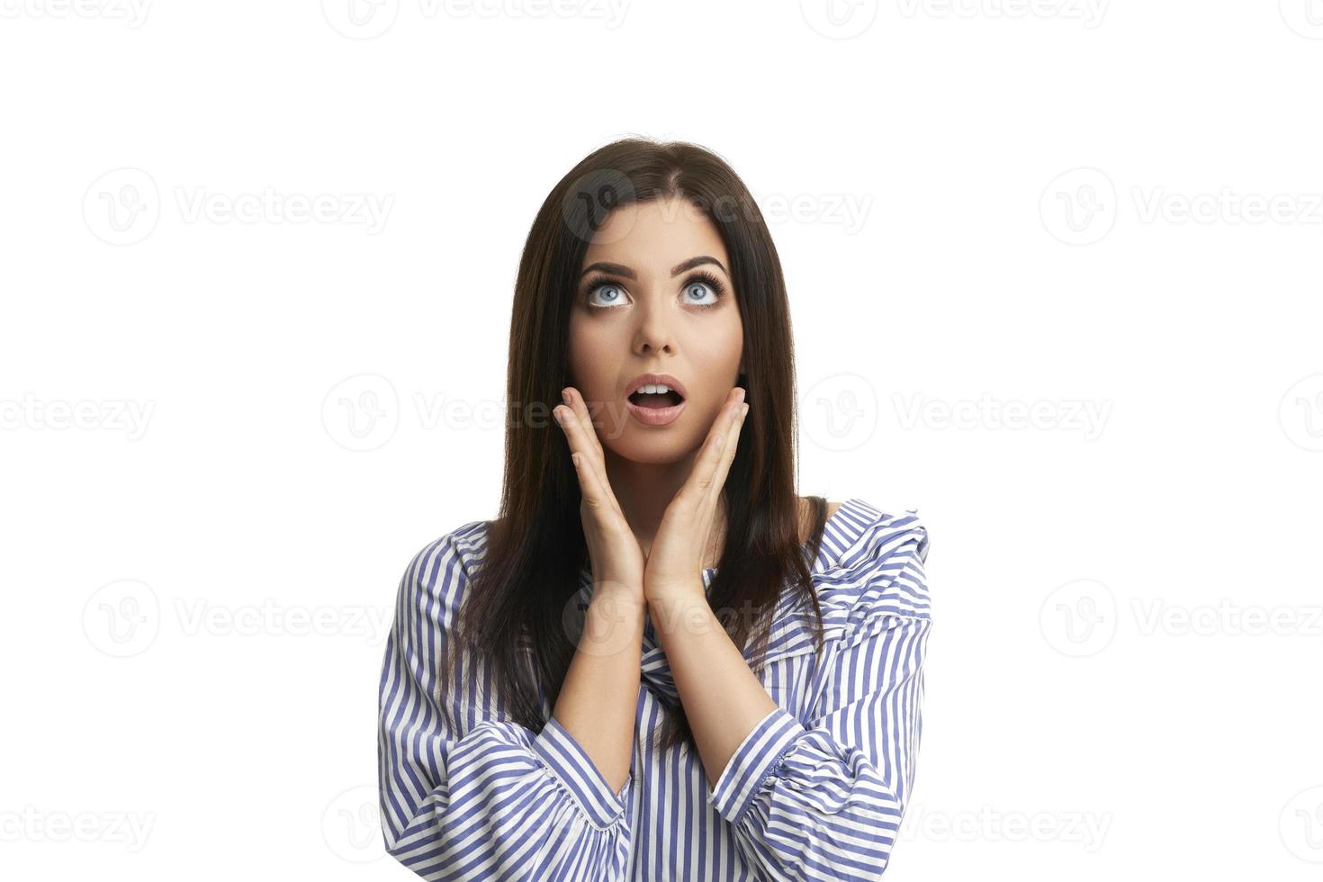 Shocked girl covers her face with hands isolated on white photo