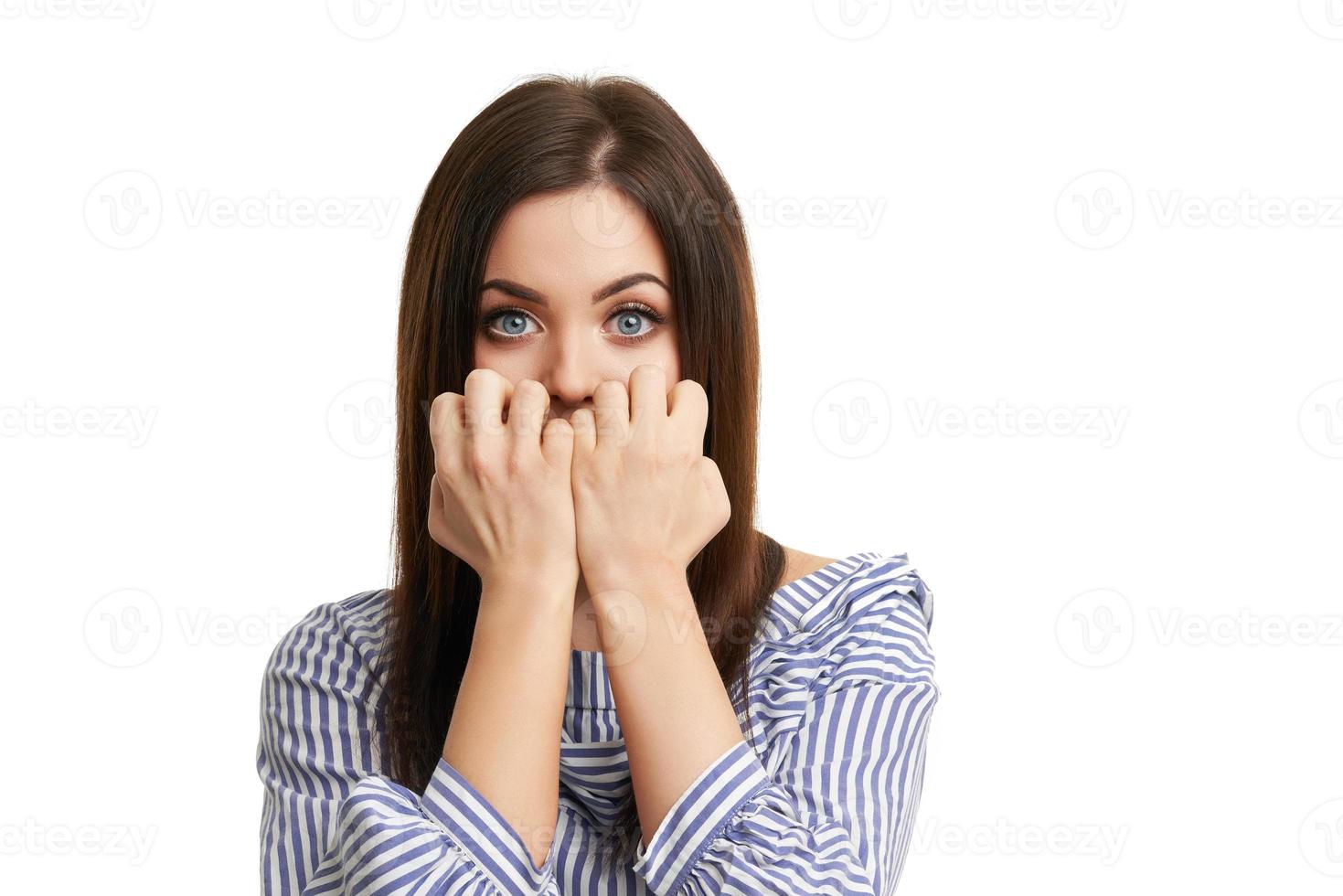 Shocked girl covers her face with hands isolated on white photo