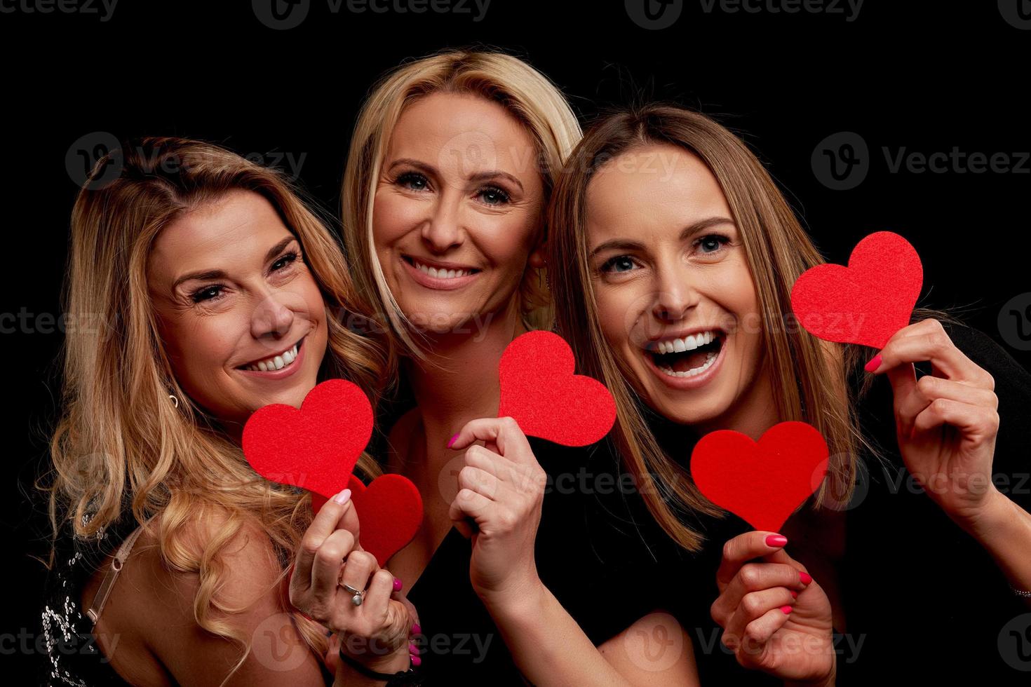 Group of friends partying and holding hearts photo