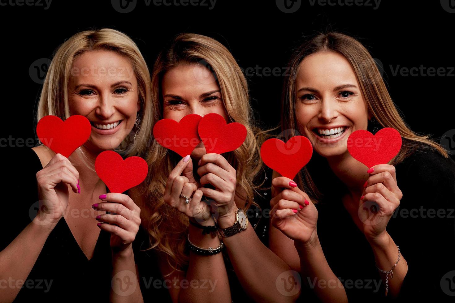 Group of friends partying and holding hearts photo