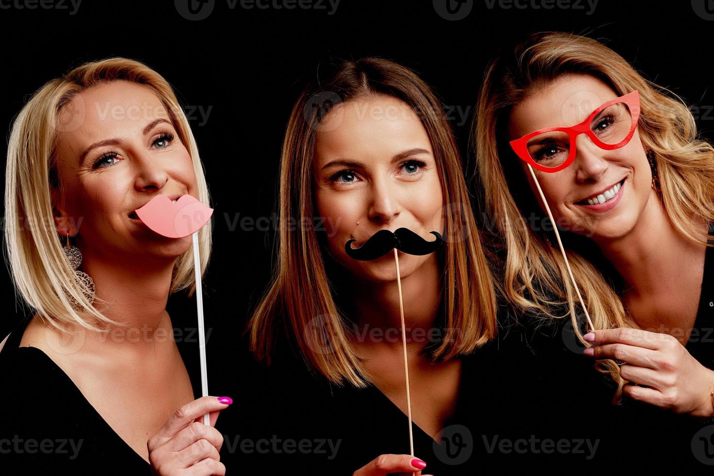 Group of friends partying in a nightclub and toasting drinks photo