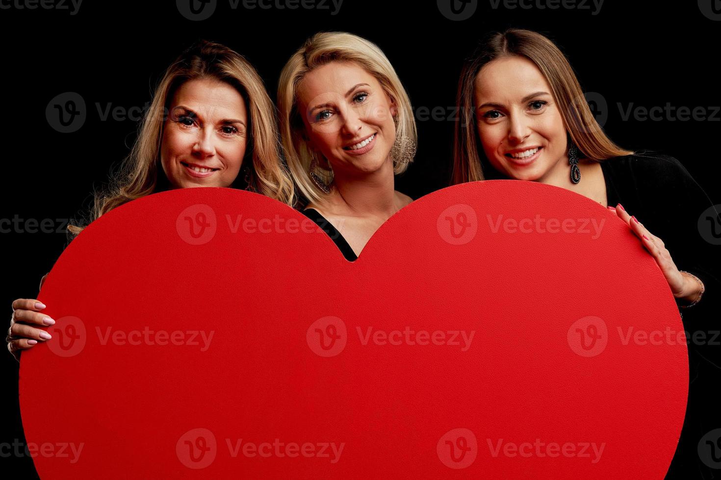 Group of friends partying and holding hearts photo