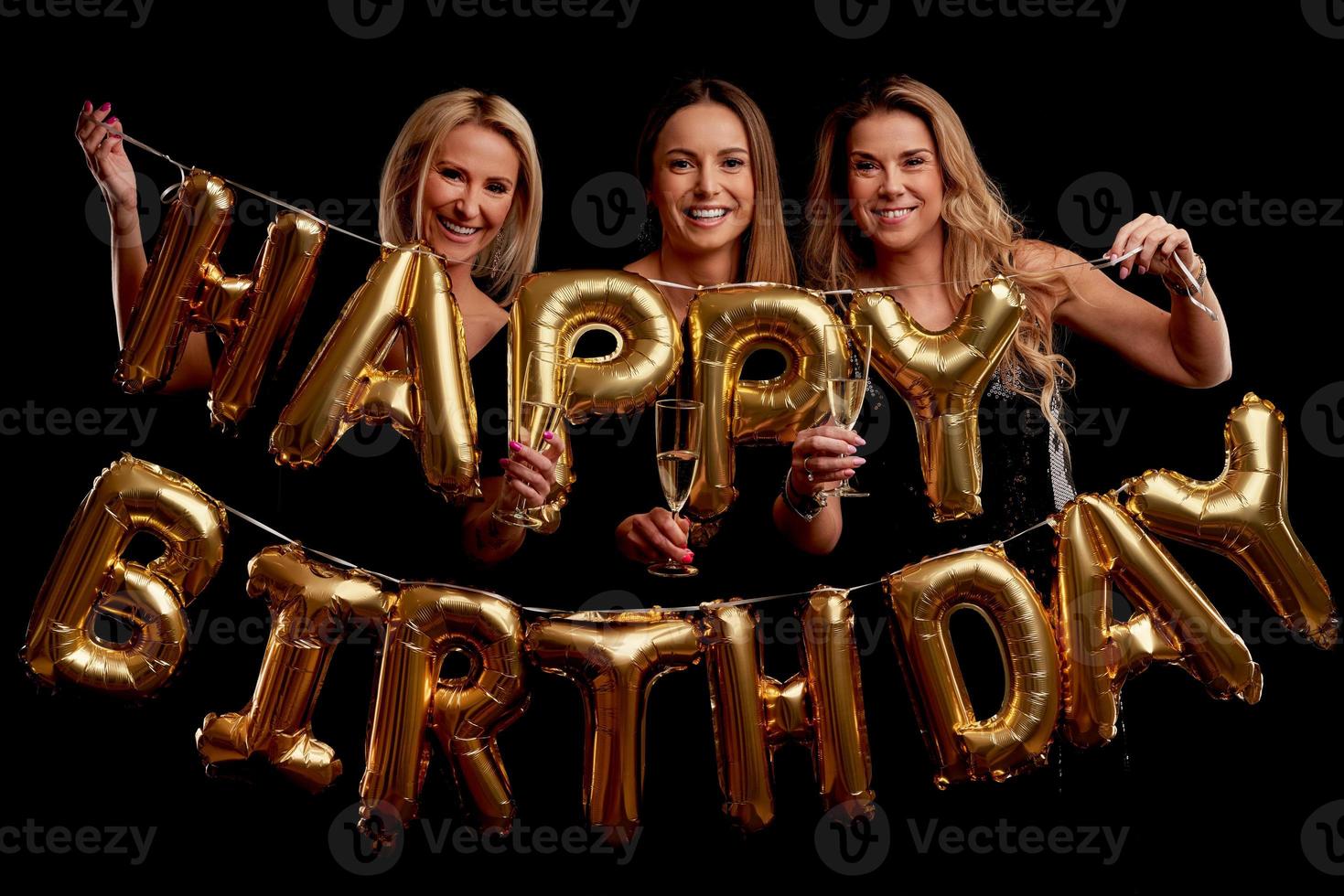 Group of friends partying in a nightclub and toasting drinks photo