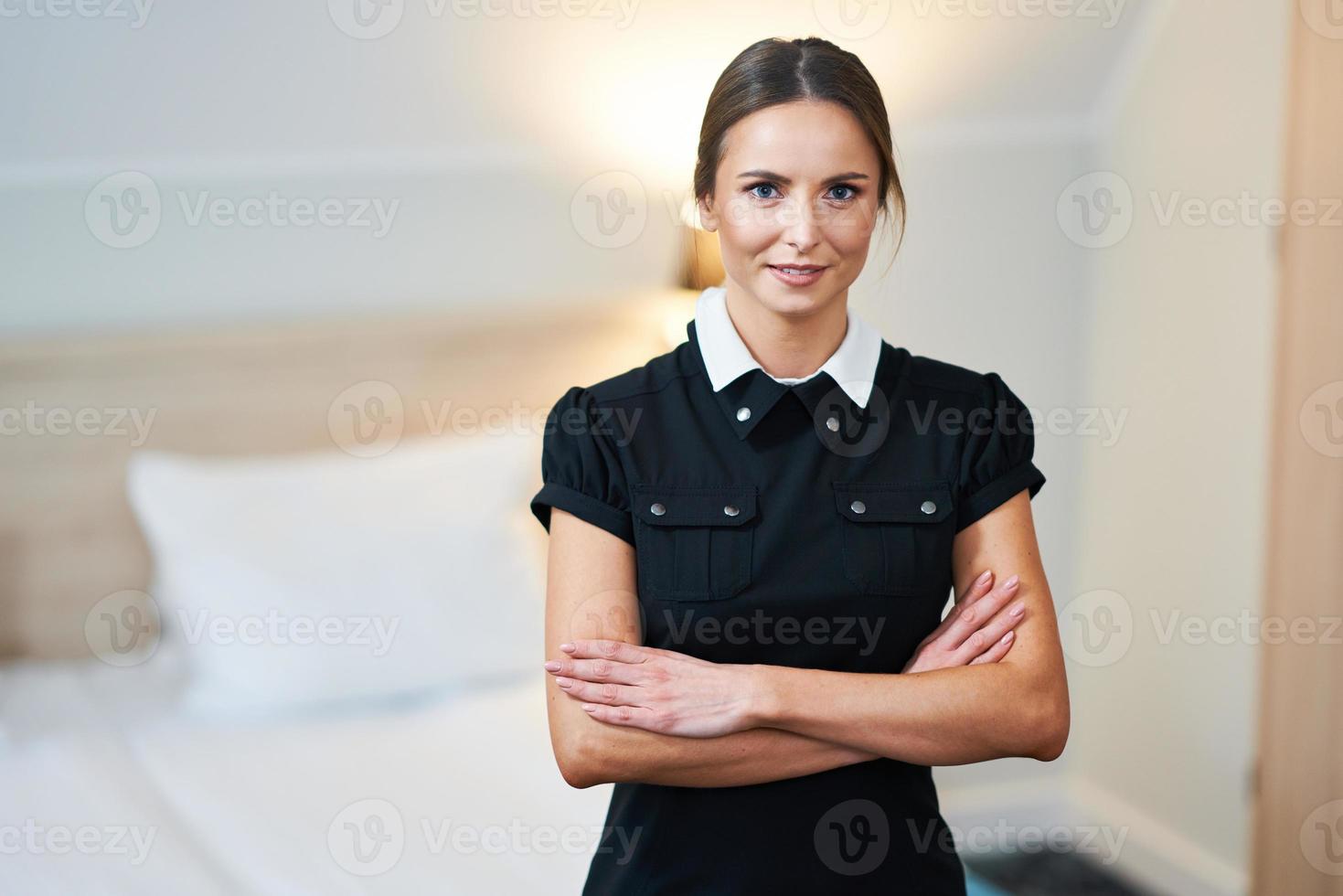 Maid standing in hotel room photo