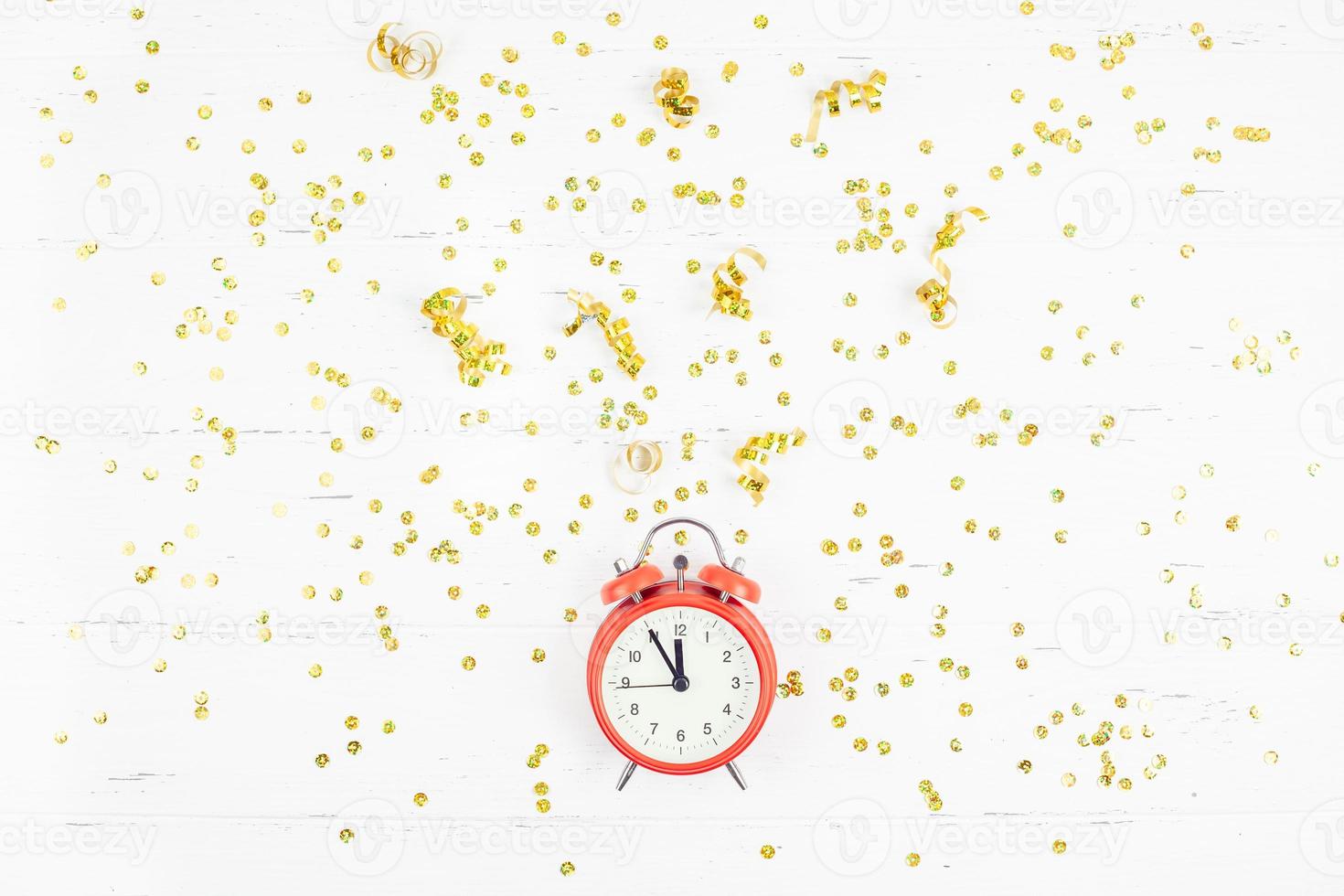 New Year composition alarm clock golden confetti photo