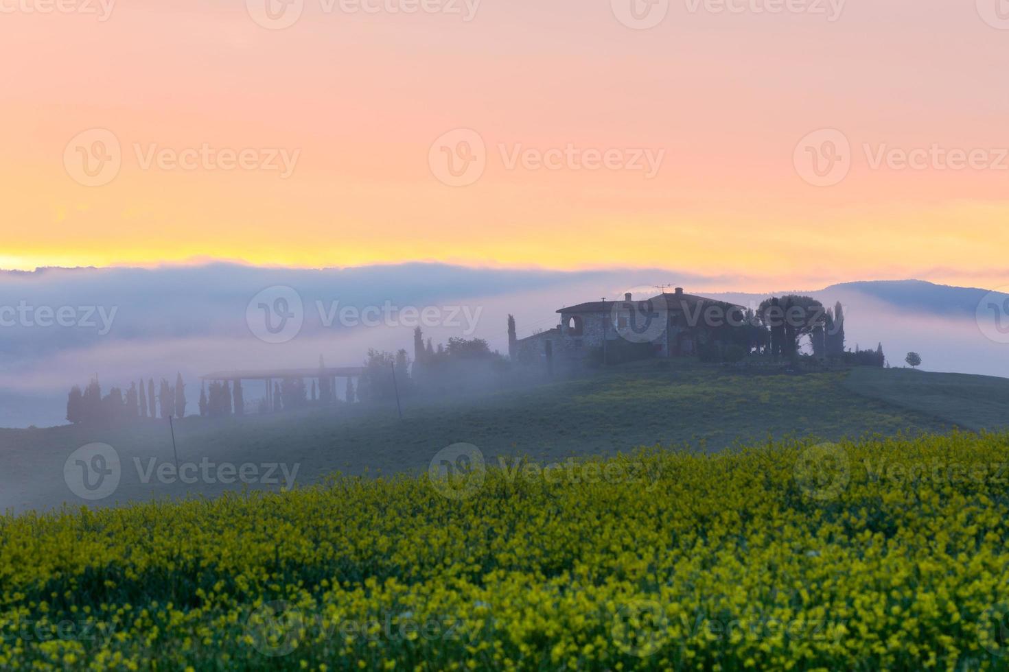 Morning fog view on farmhouse in Tuscany, Italy photo