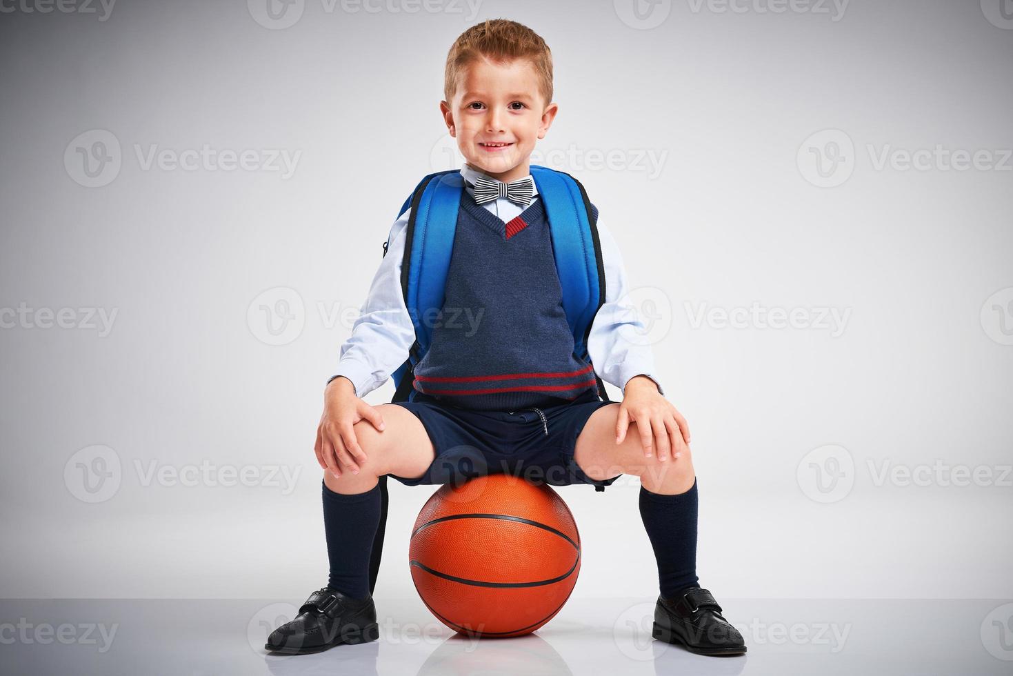 Portrait of a boy ready to school isolated on white photo