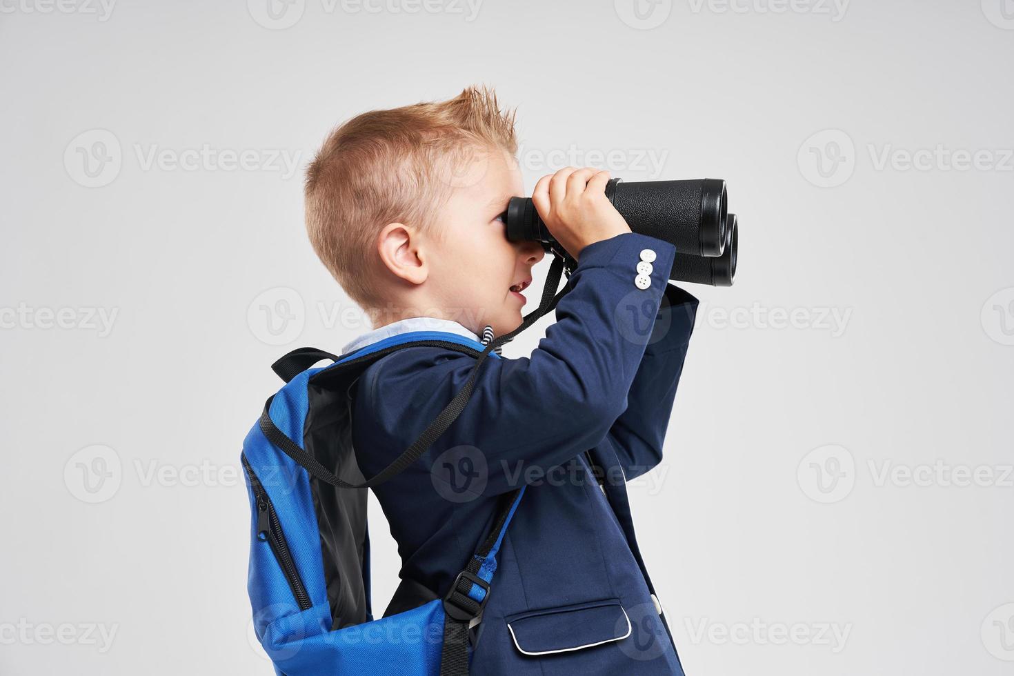 Portrait of a boy ready to school isolated on white photo