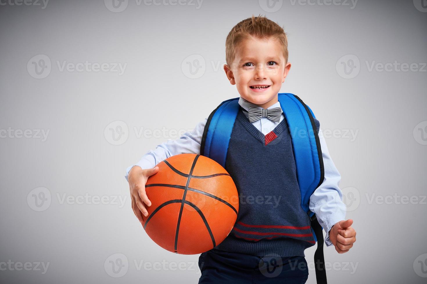 Portrait of a boy ready to school isolated on white photo