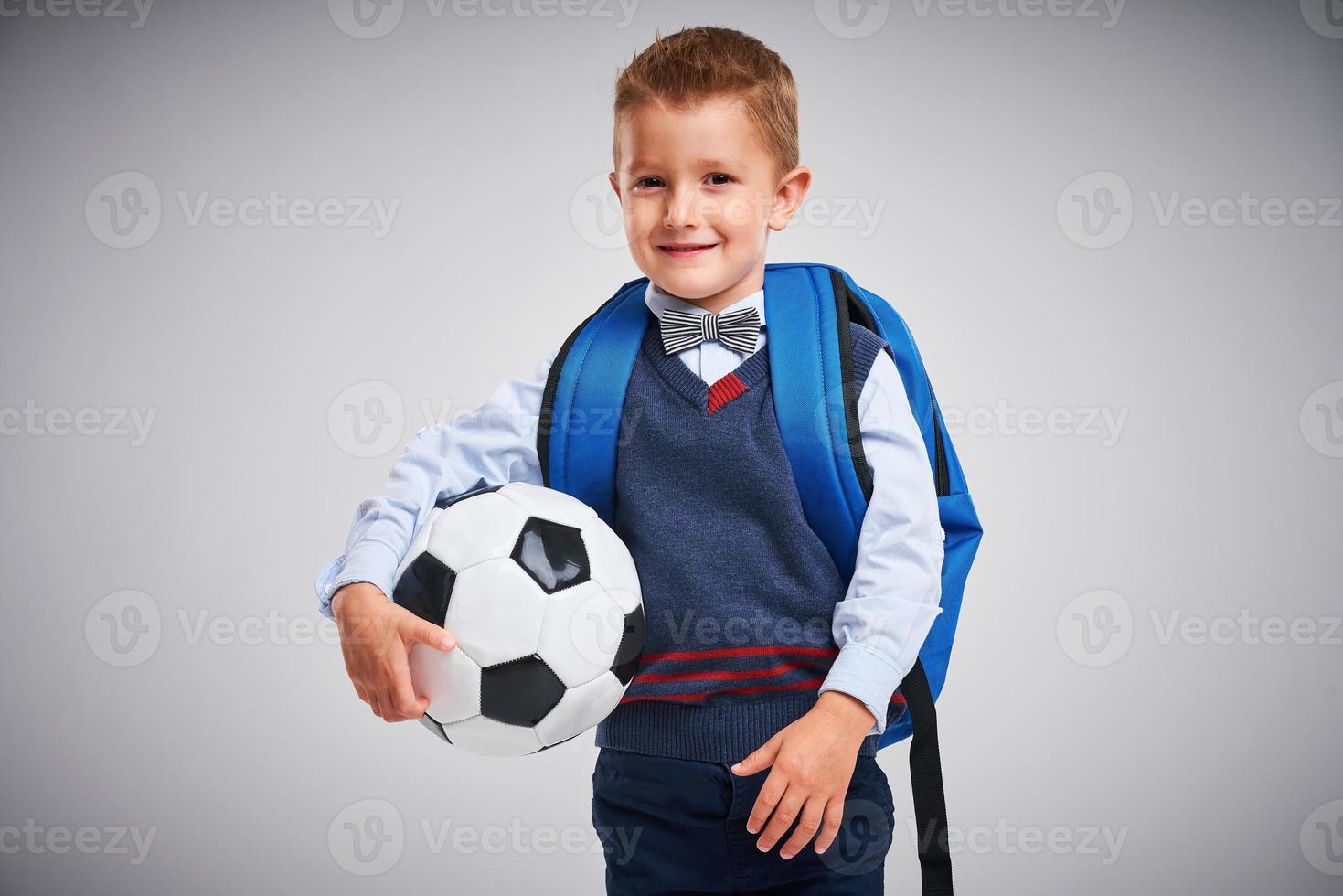 Portrait of a boy ready to school isolated on white photo