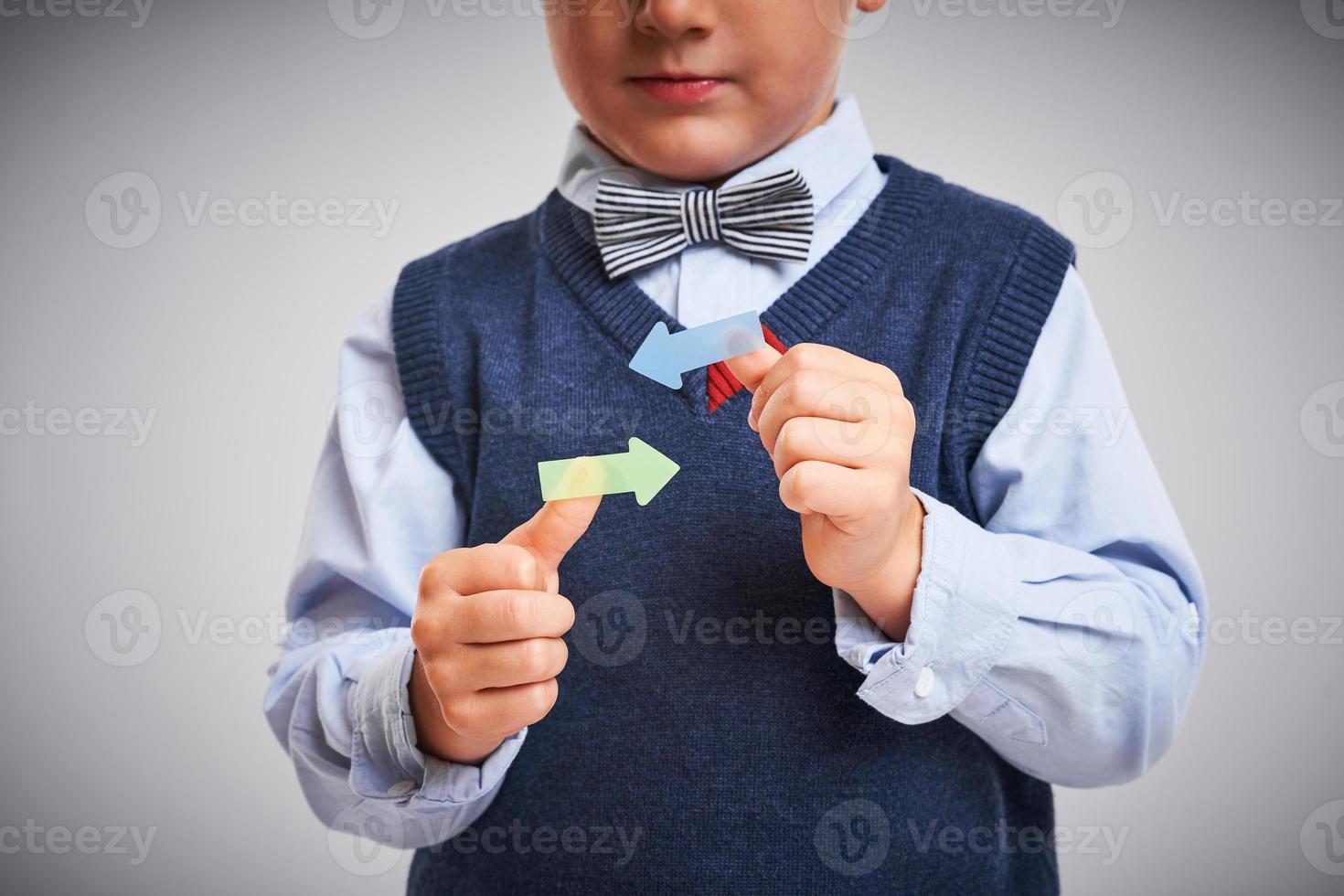 Portrait of a 4 year old boy posing over white with arrows photo