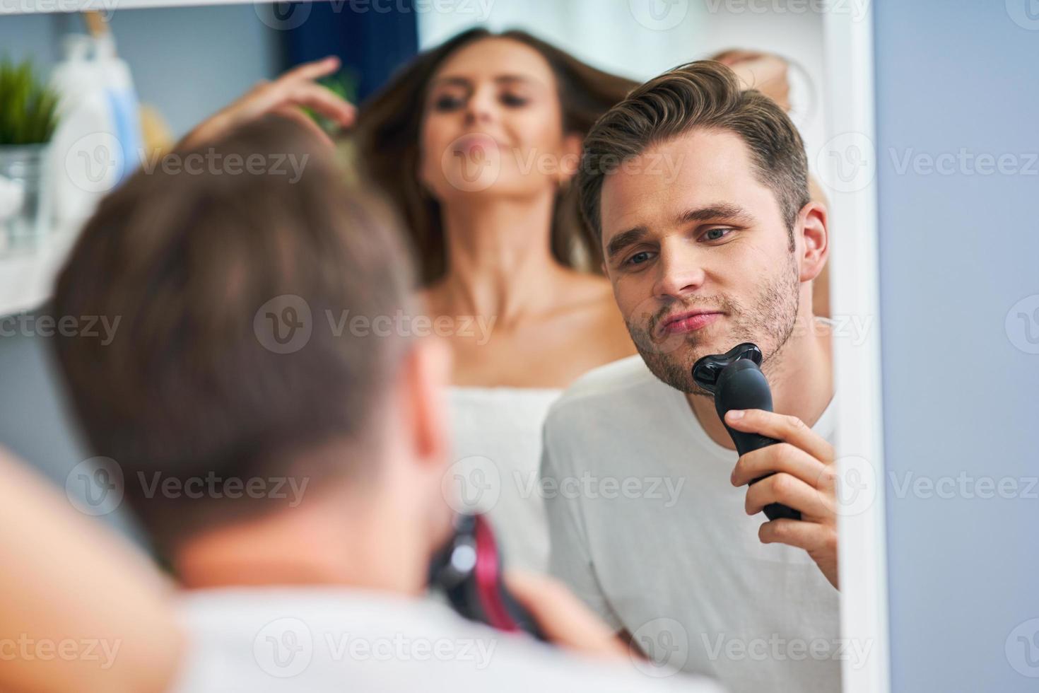 Portrait of happy young couple in the bathroom photo