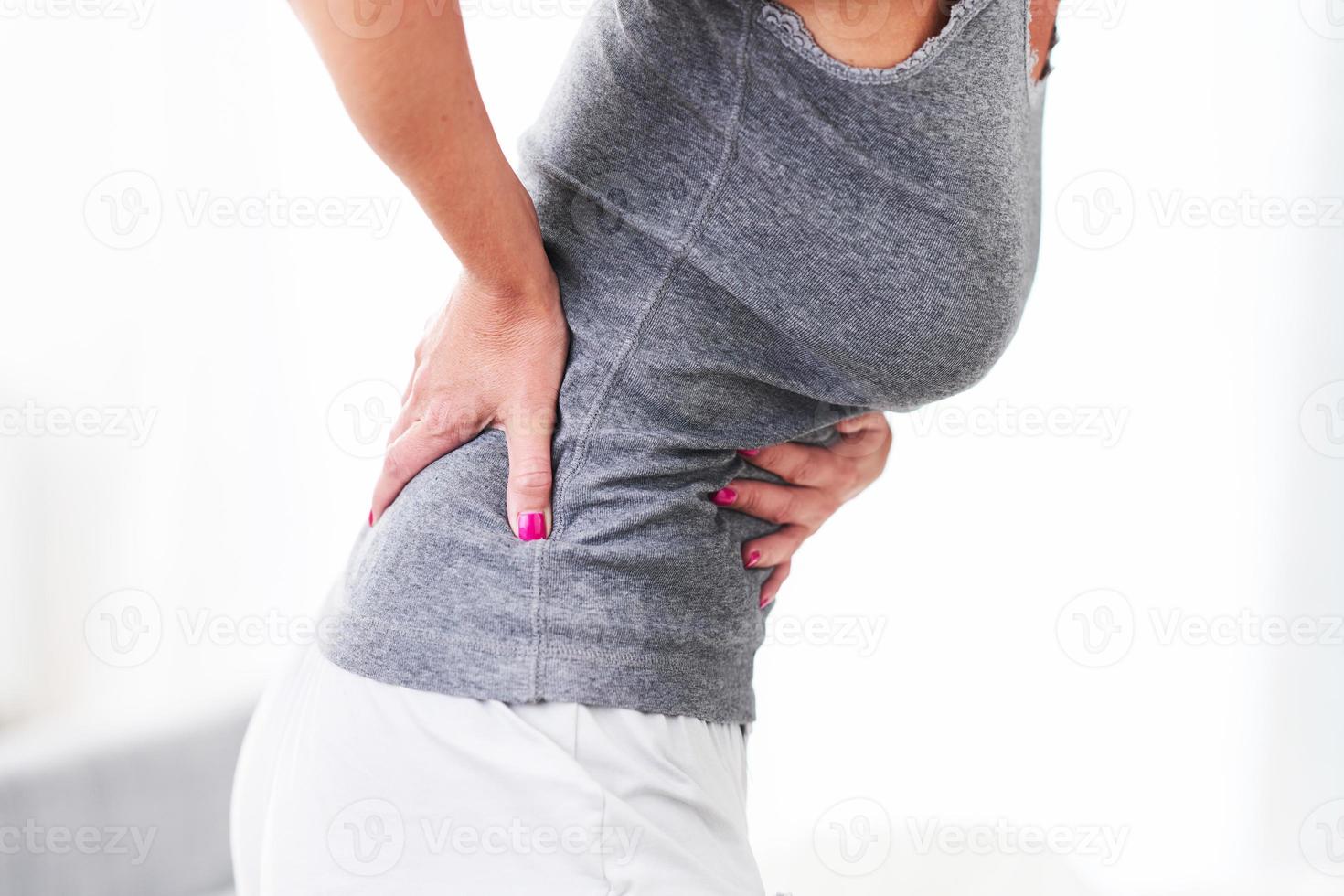 Adult woman feeling unewll suffering from menstruation pain photo