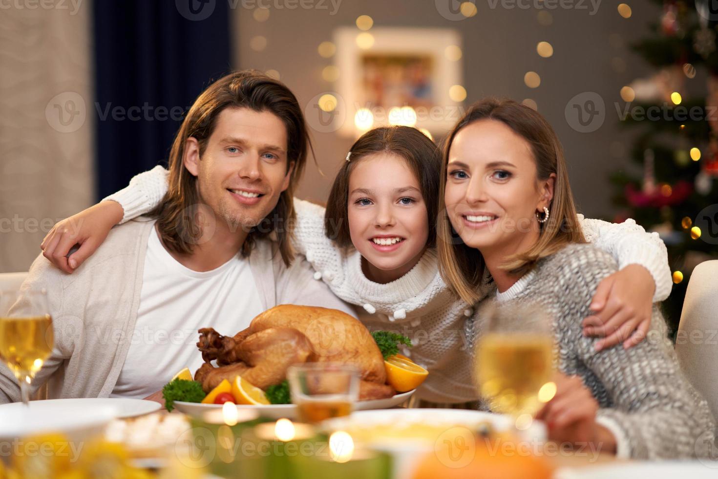 Beautiful family eating Christmas dinner at home photo