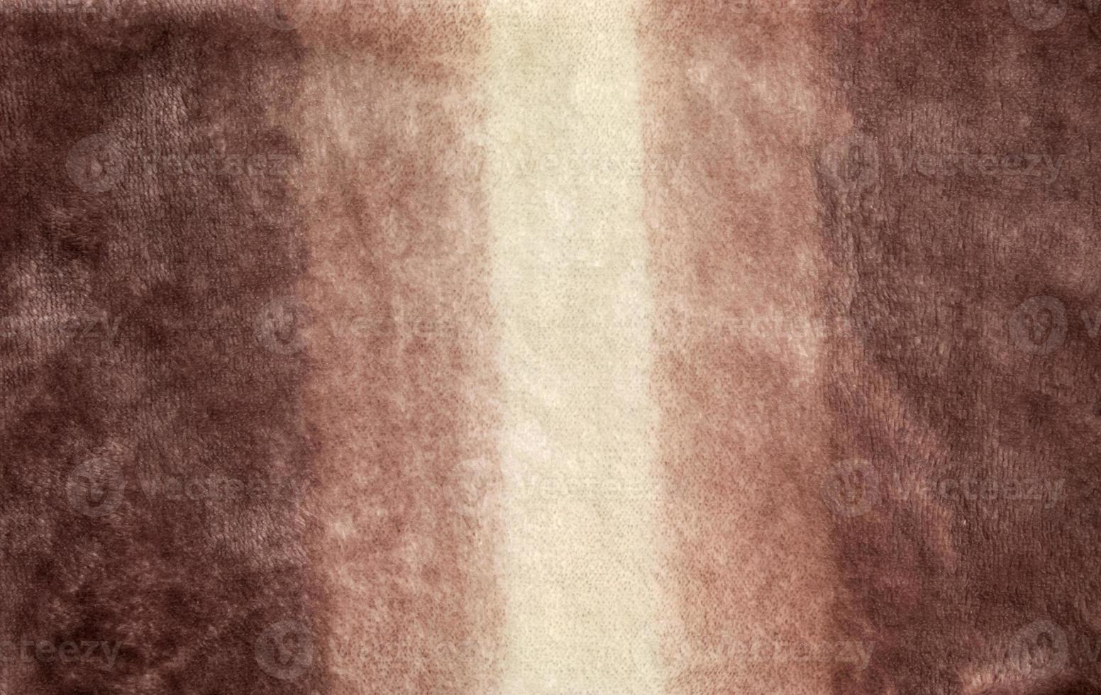 Close-up pattern of fleece fabric. Shades of beige on the surface of fur clothes, abstract texture background. photo