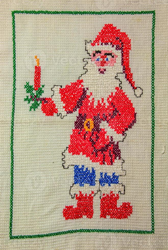 Santa Claus. Cross stitch for Christmas. Handmade napkin for the New Year. photo