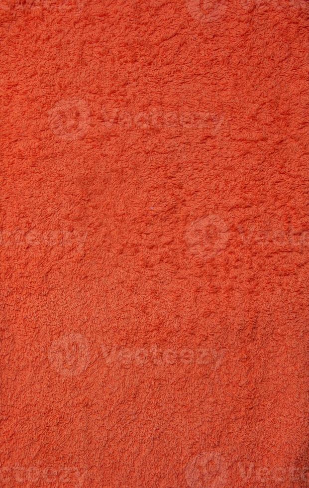 Orange terry towel background. Terry cloth texture photo