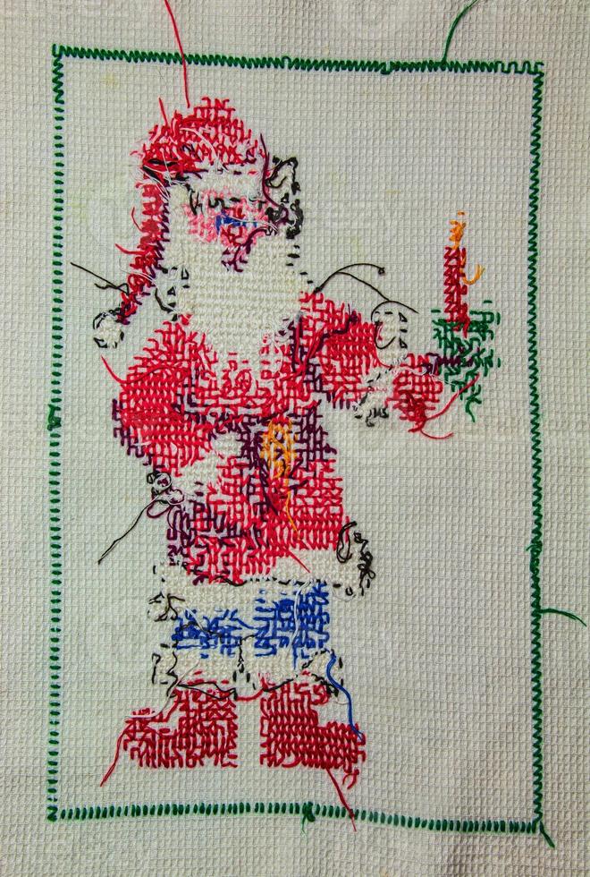 Santa Claus. Cross stitch for Christmas. Handmade napkin for the New Year. View from the back. photo