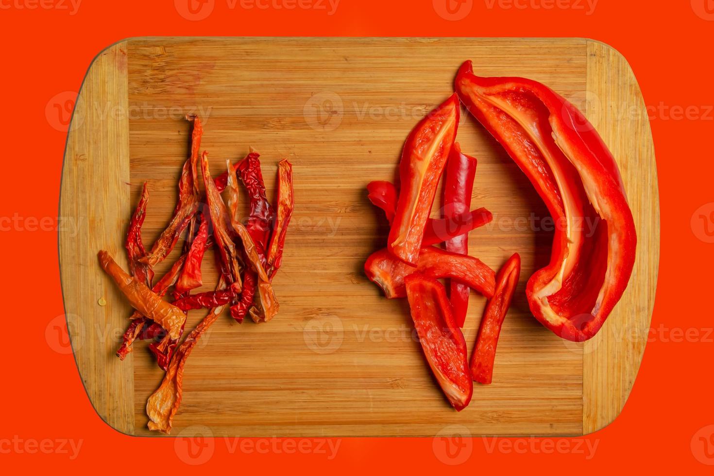 chips de pimiento rojo seco kappia campana dulce, pimentón y rodajas de pimiento fresco en una tabla de cocina de madera. cerrar, copiar espacio. foto