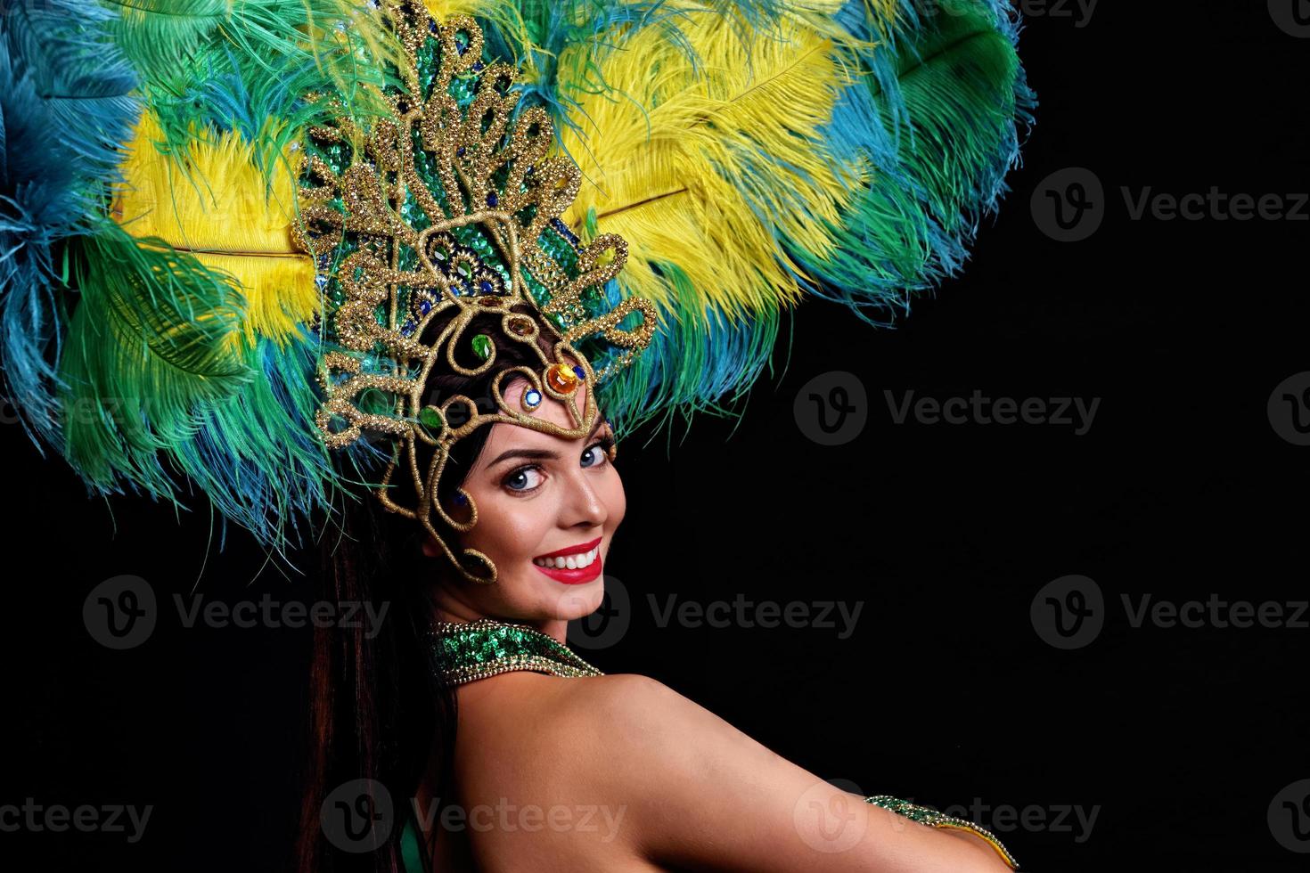 Brazilian woman posing in samba costume over black background photo