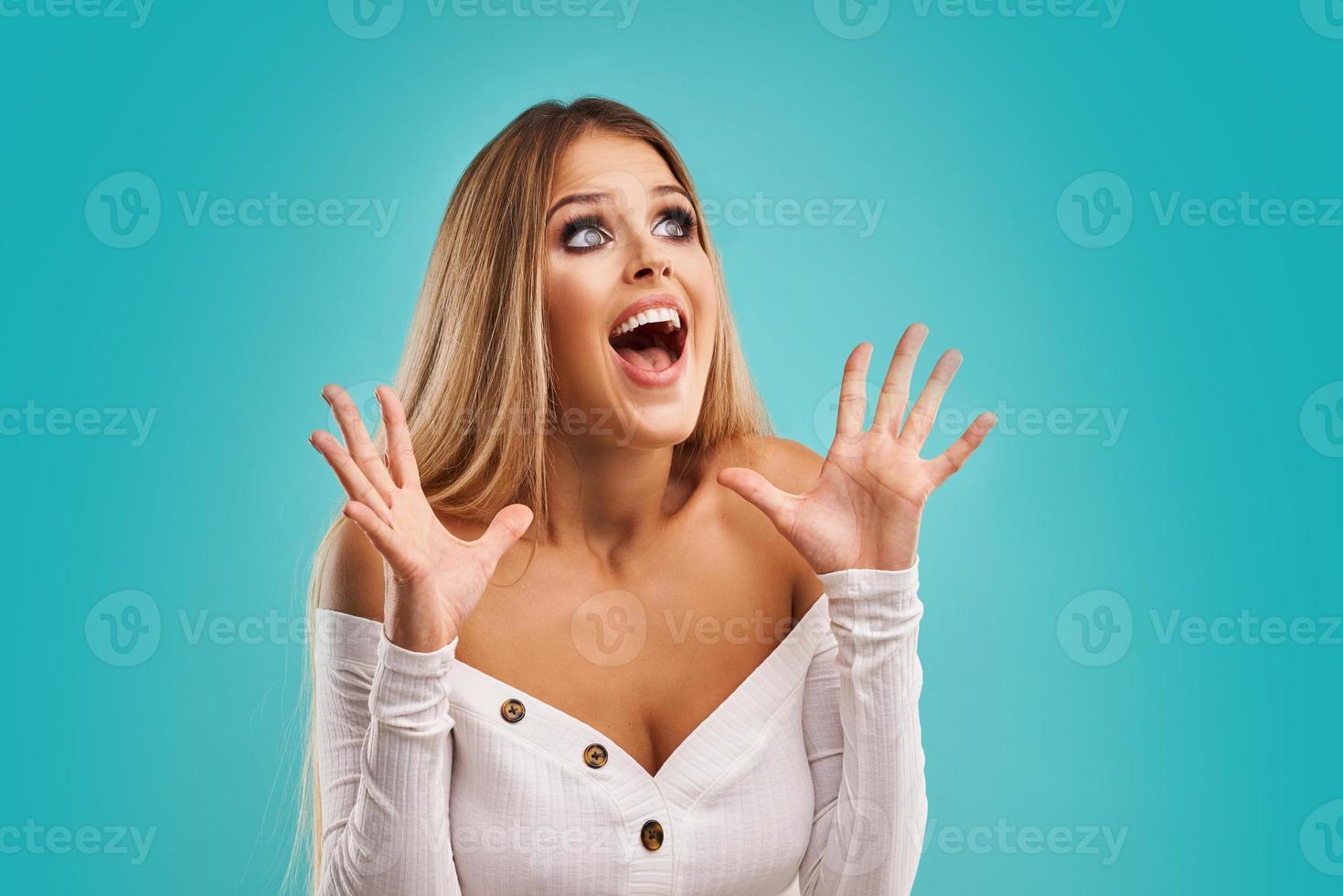 Beautiful adult woman posing over blue background photo