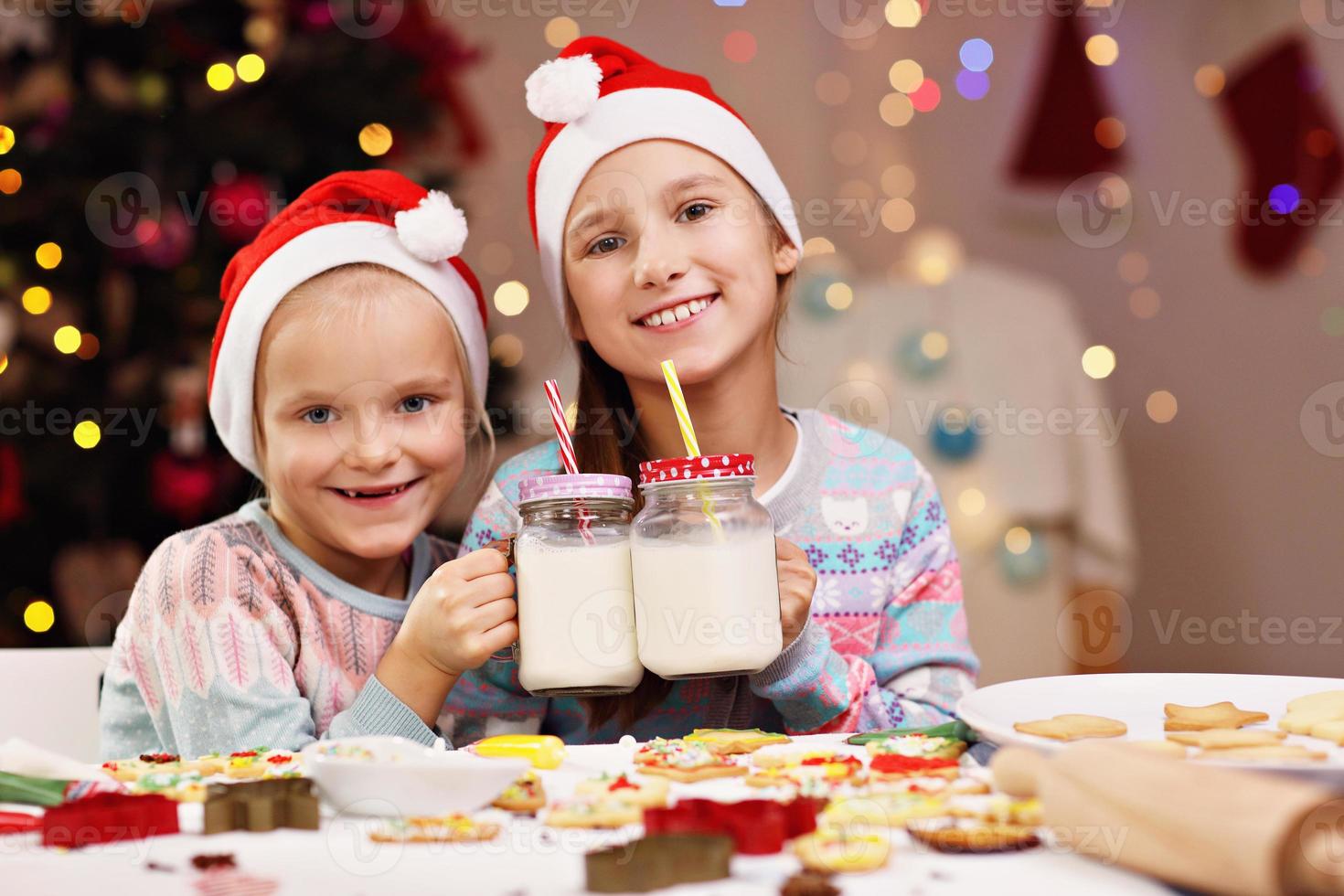 Happy little sisters preparing Christmas biscuits photo