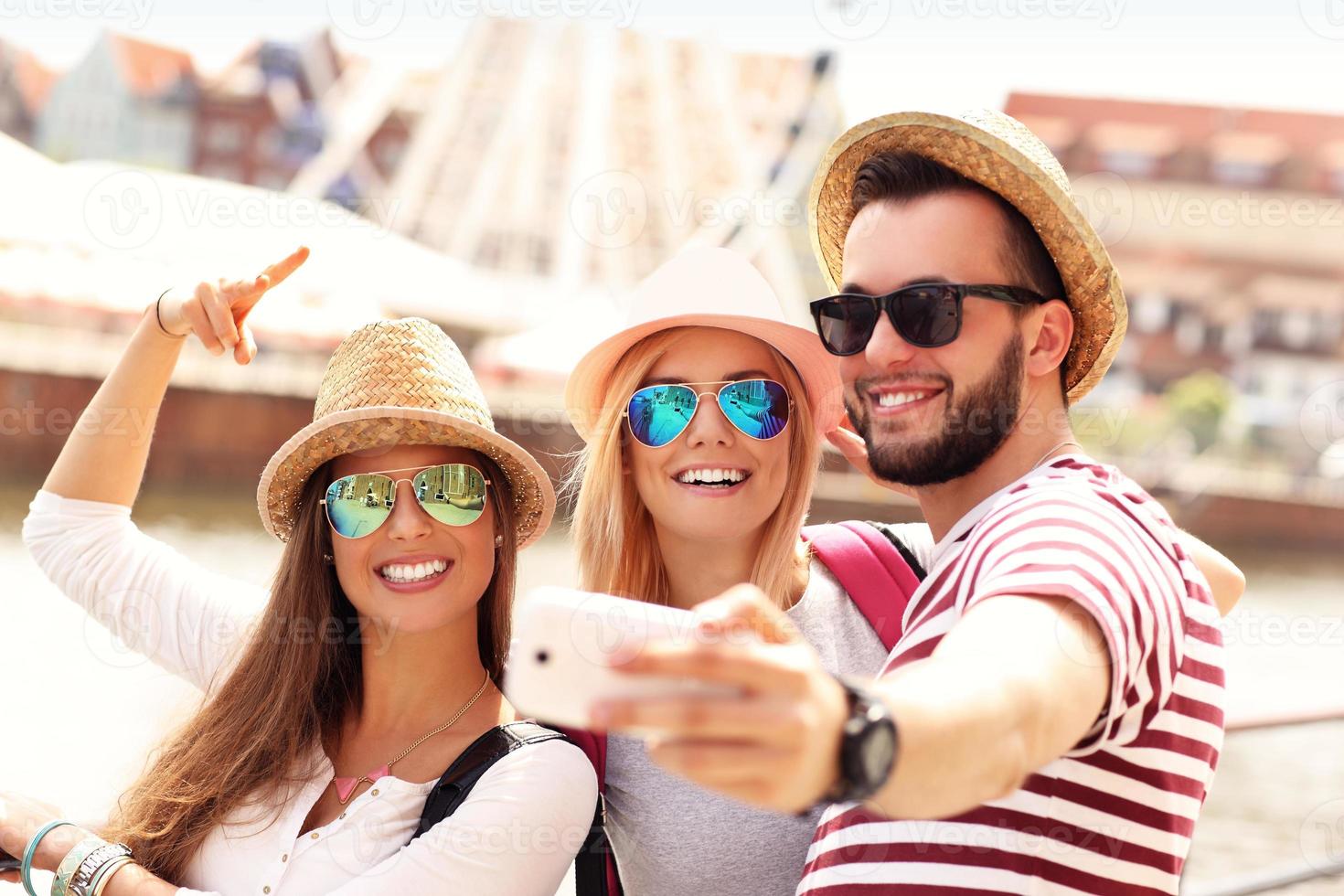 Group of friends hanging out in the city and taking selfie photo